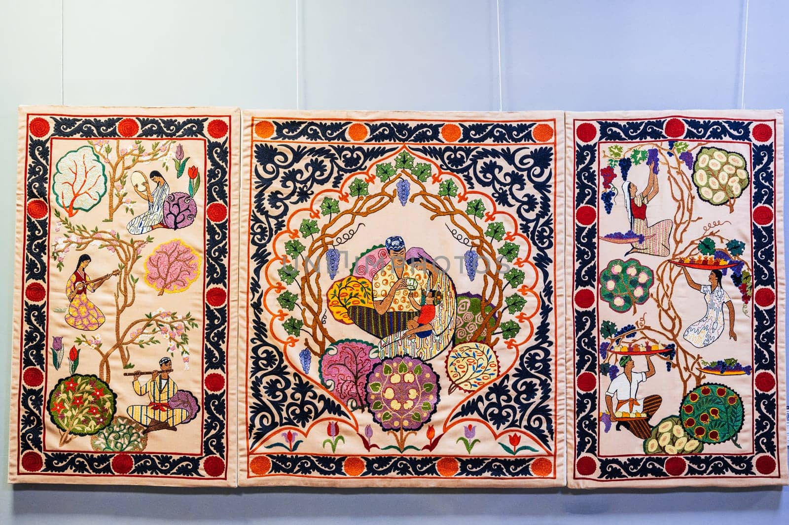 oriental Uzbek carpets with a traditional pattern. Vintage Asian handmade embroidered carpets on the wall in Uzbekistan