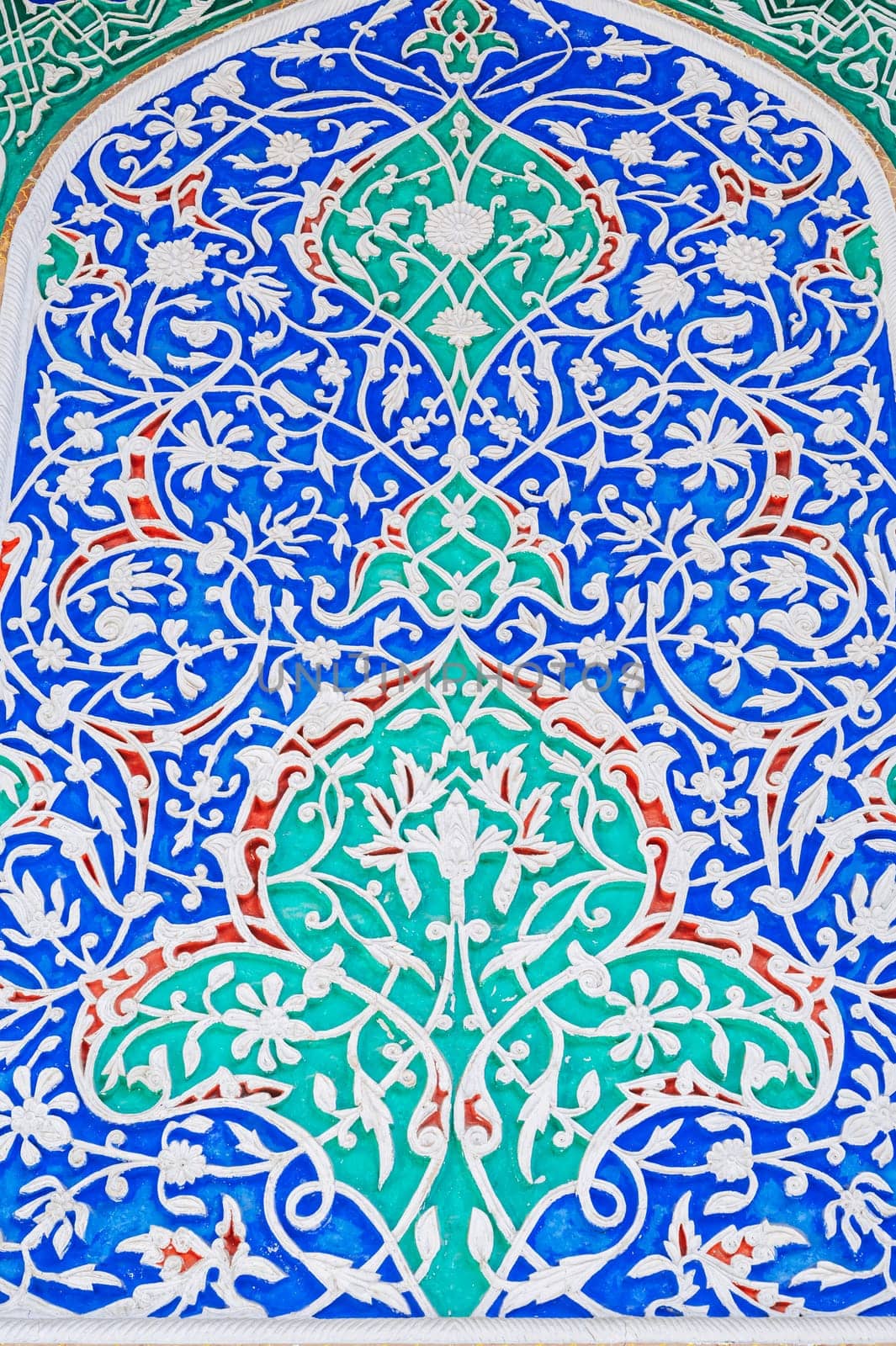beautiful background of carved wooden painted wall in the Museum of Art of Uzbekistan with Uzbek ornaments and colorful oriental patterns in Tashkent
