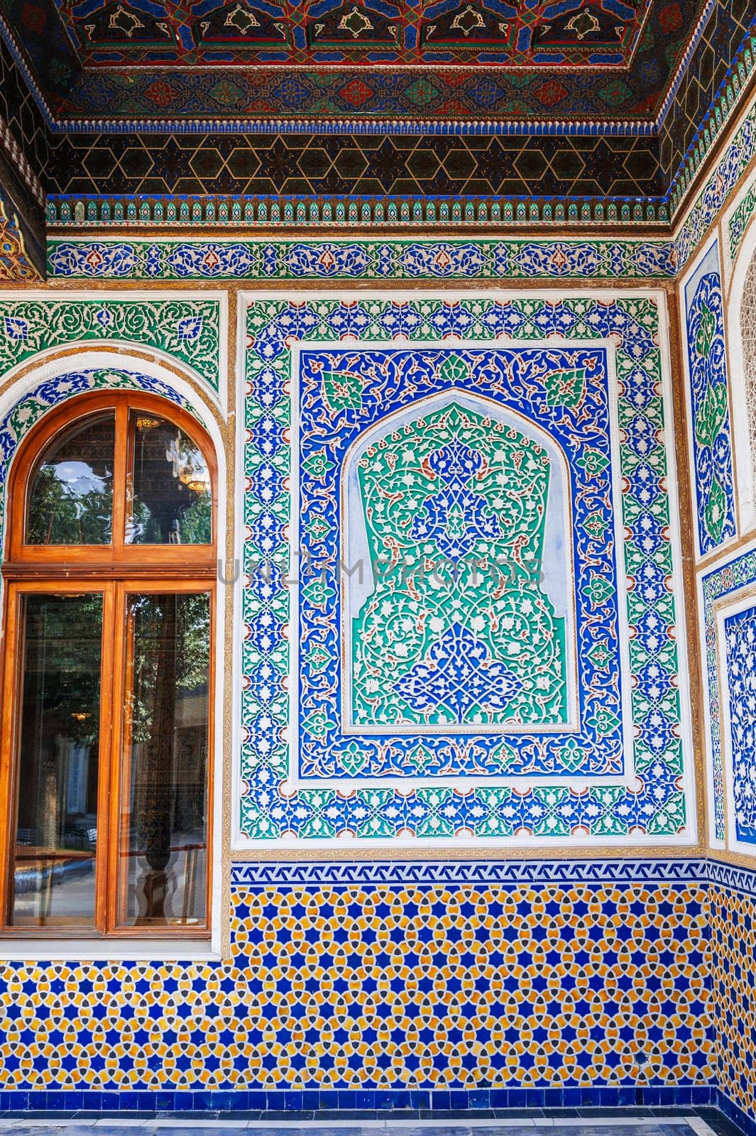 beautiful art carved wooden painted wall in the Museum of Art of Uzbekistan with traditional Uzbek ornaments and colorful oriental patterns in Tashkent