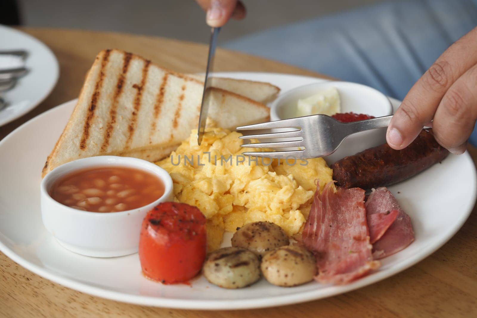 Breakfast includes scrambled eggs, toast, and various sides served on a plate.