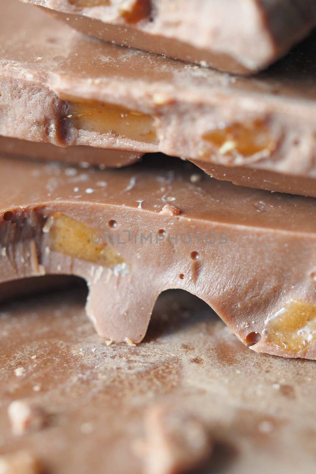 Close-up of chocolate bark featuring fruit pieces on a countertop.