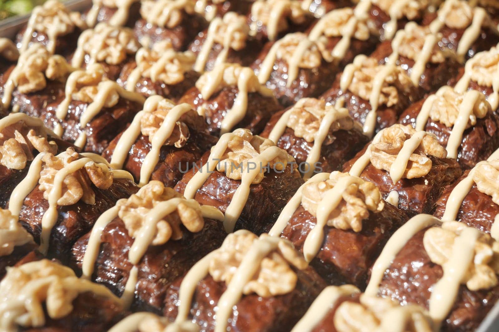 Delicious turkish baklava decorated with creamy topping and nuts,