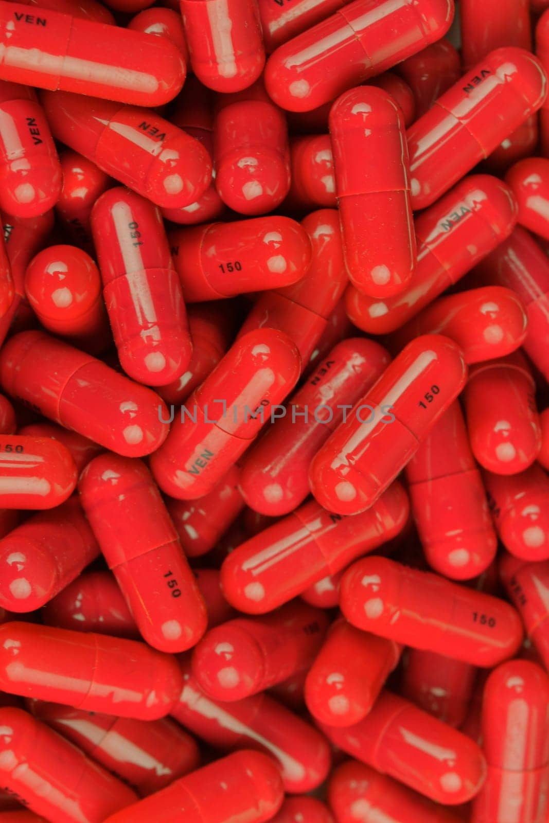 Red medicine capsules in a pile. Medication pills in capsules on a pile. The concept of medicine, medicine and healthful lifestyle.