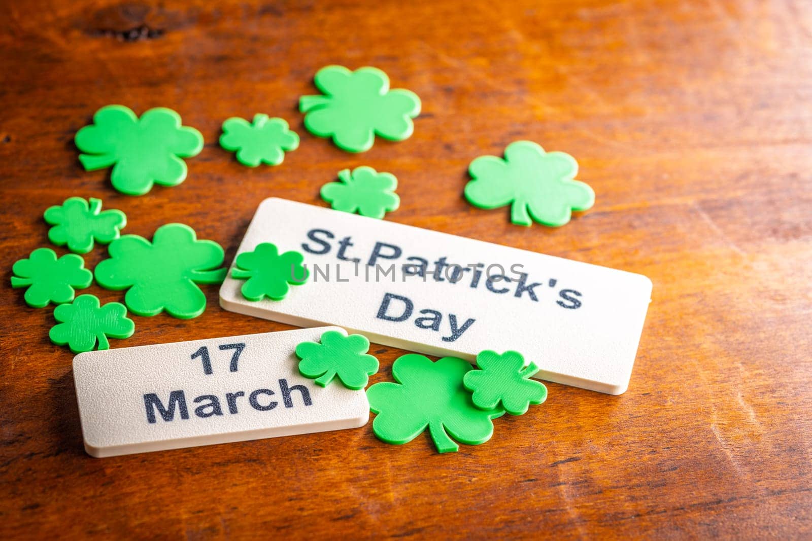 St. Patrick's Day. Green clover leaves decoration on a wooden table.