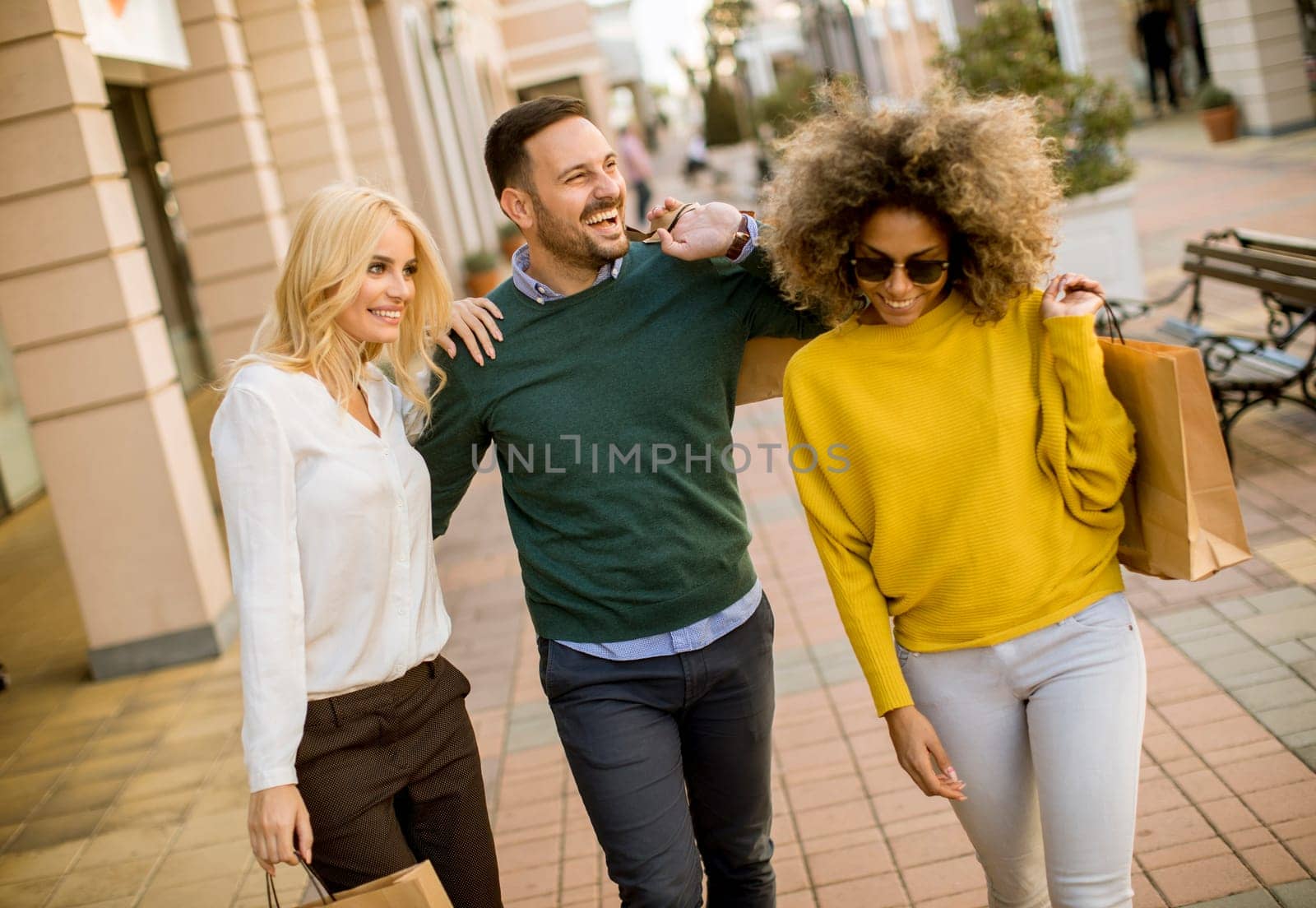 Group of young multiracial friends shopping in mall together
