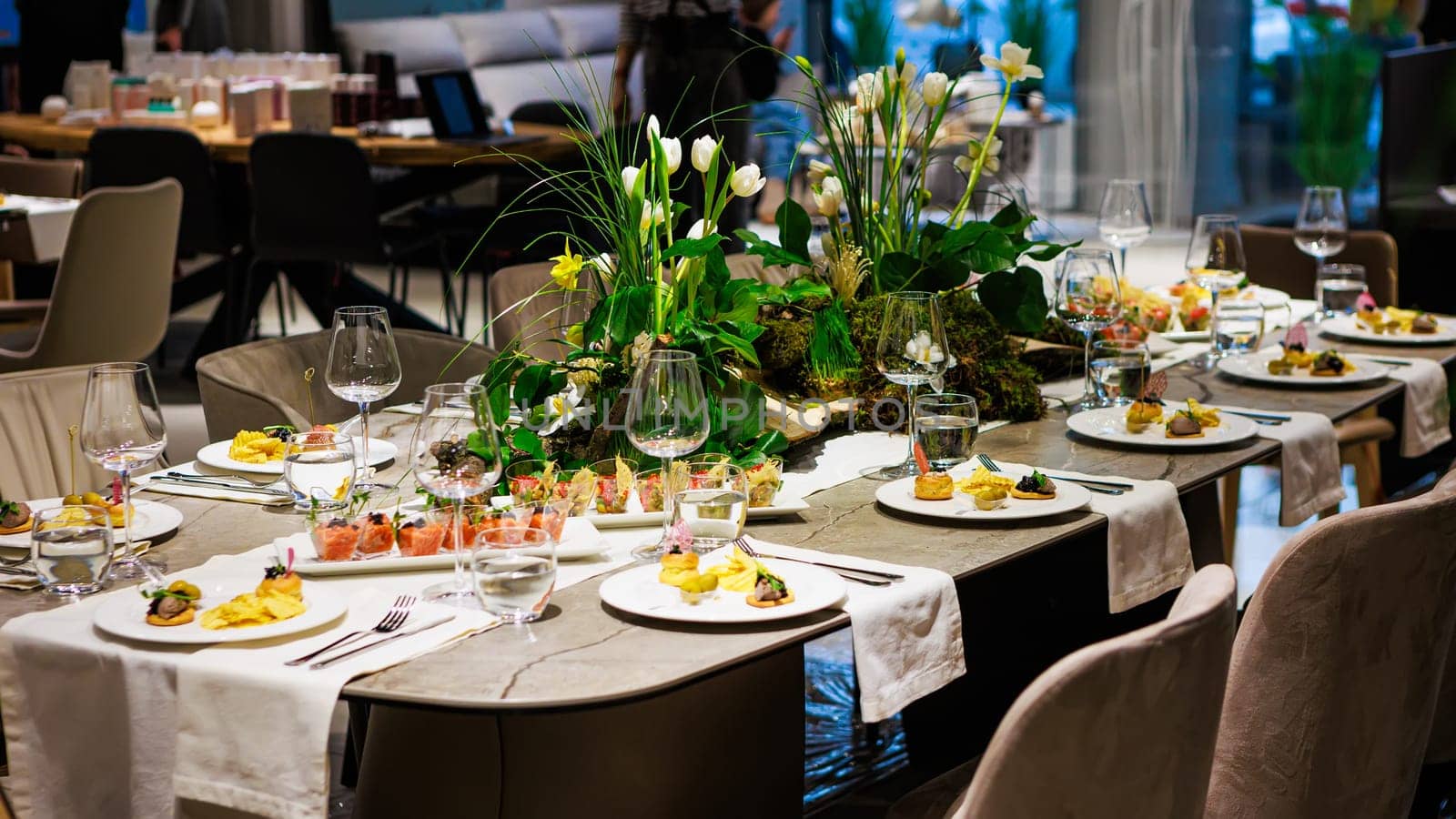 Elegant table decor for luxury dining with floral centerpieces, gourmet appetizers, stylish glassware, and sophisticated table settings ideal for upscale events.