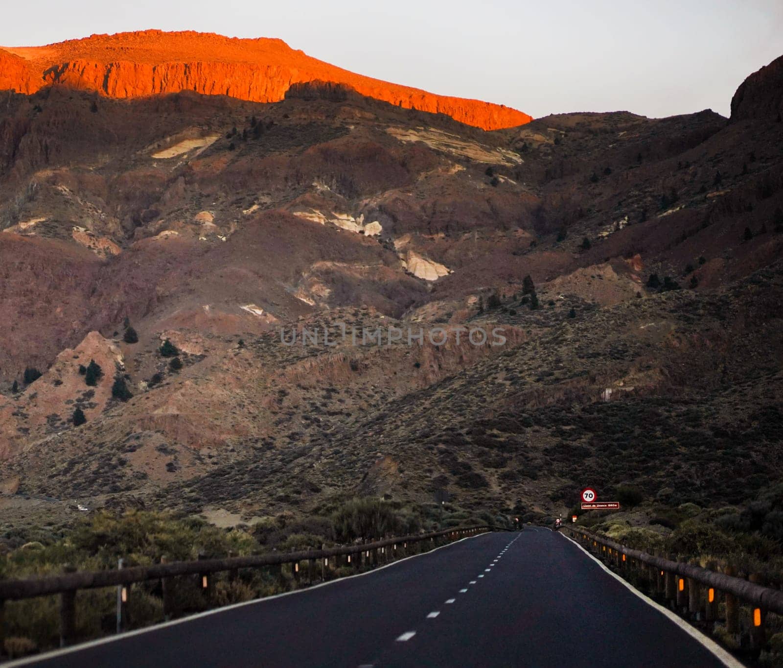A picturesque road among dramatic rocks and mountains to the Teide volcano in the last rays of the sun before sunset, discovering a national park on the island of Tenerife, Canary island.