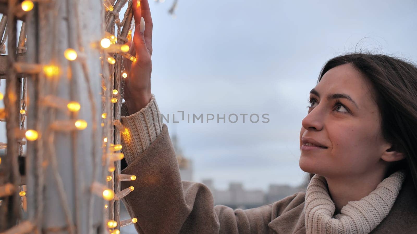 Happy girl on the background of Christmas garland