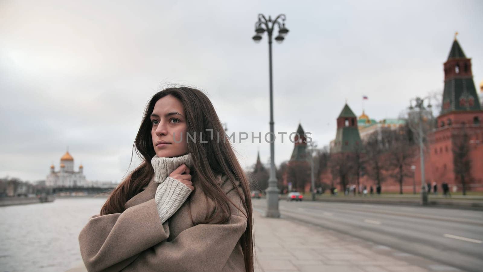 Sad girl froze waiting for a taxi by the river in Moscow