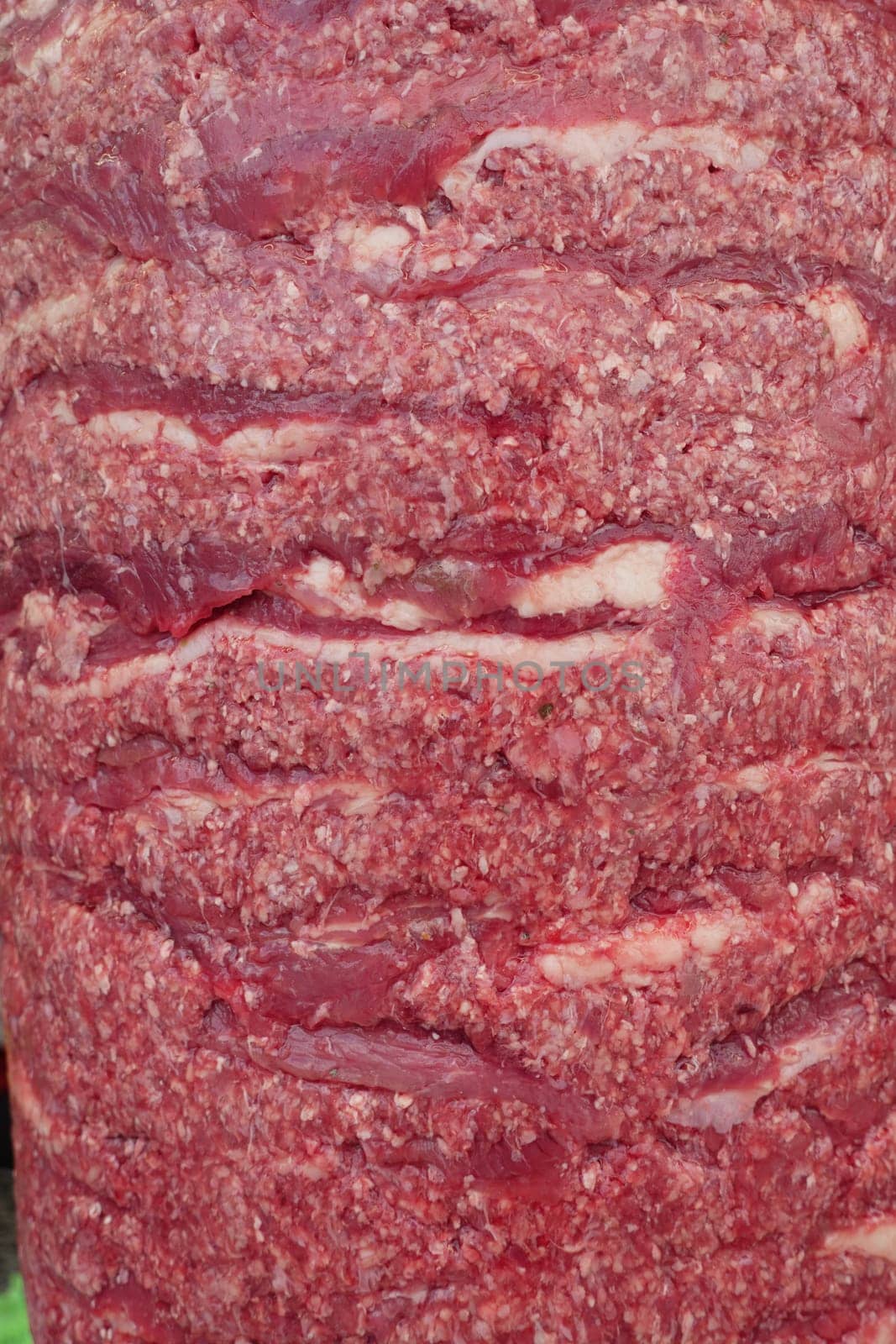 Fresh ground beef on display at a market, inviting shoppers.
