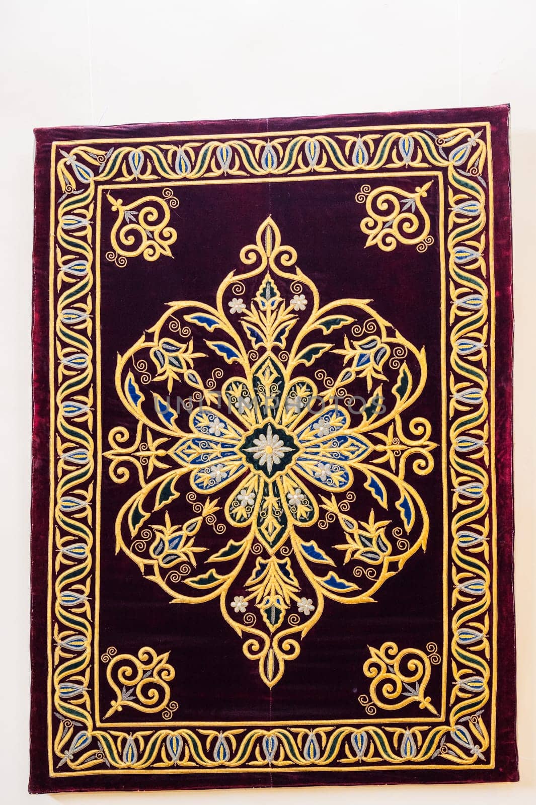 oriental Uzbek asian carpet with a traditional geometric pattern. Vintage luxury handmade Turkish carpet on white isolated background