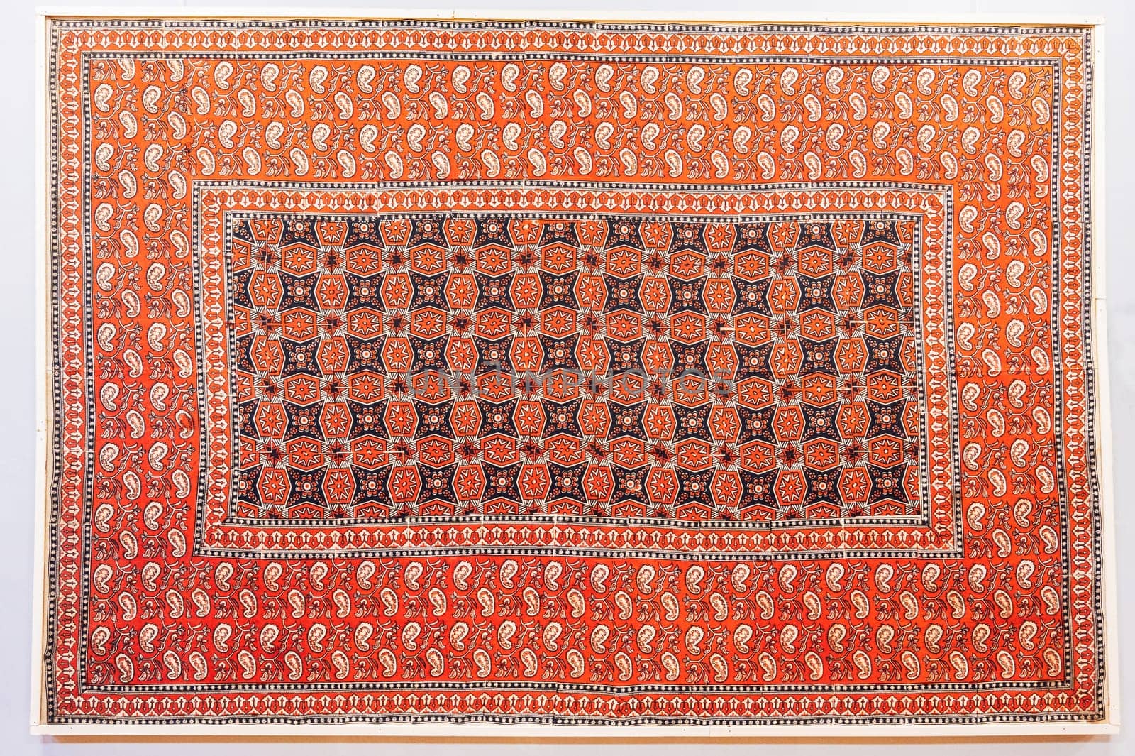 oriental Uzbek carpet with a traditional abstract geometric pattern. Vintage handmade Turkish carpet on a white isolated background