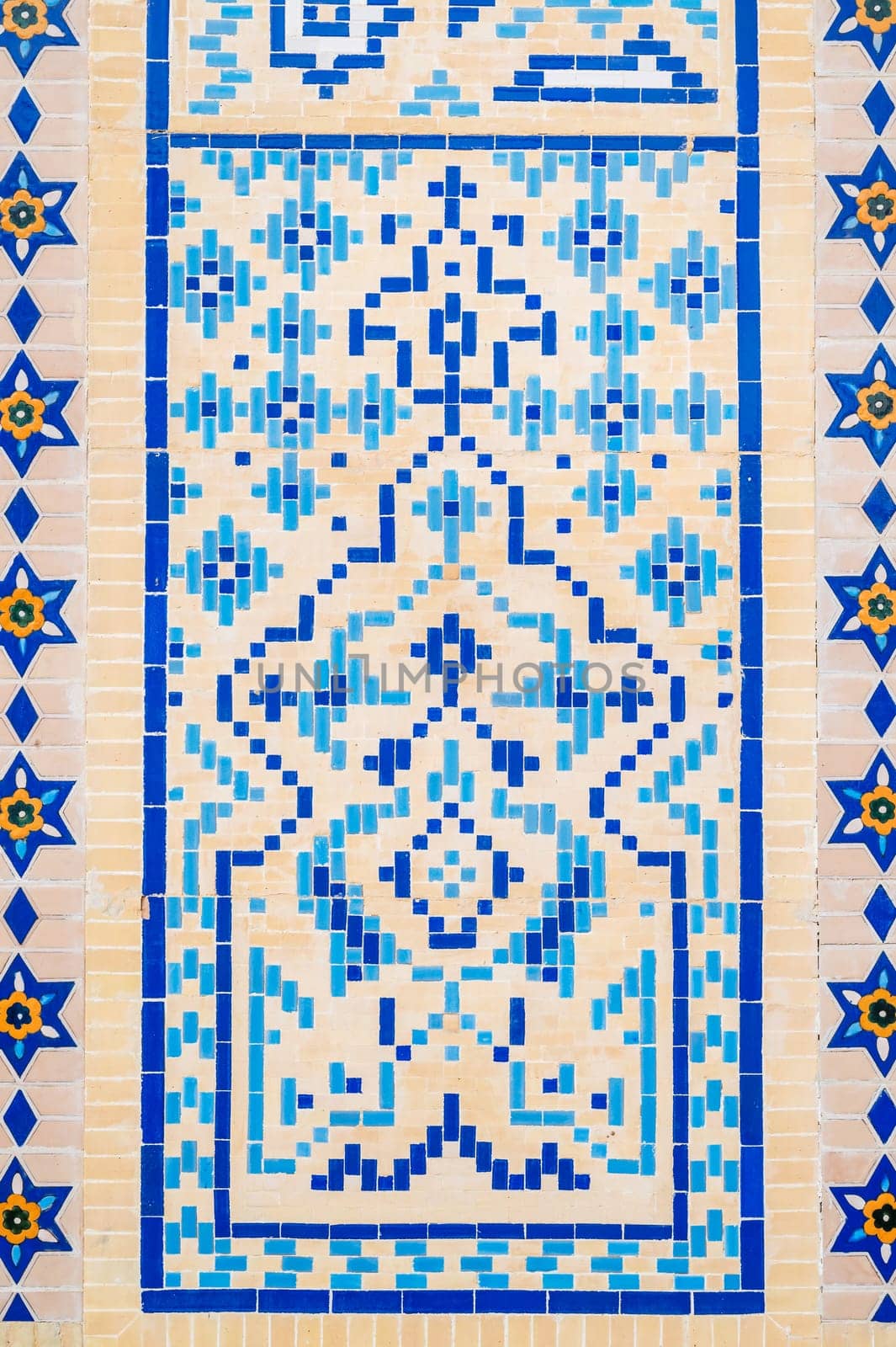 ancient old wall of Muslim mosque decorated with ceramic tiles with a traditional oriental Uzbek Islamic pattern in Uzbekistan