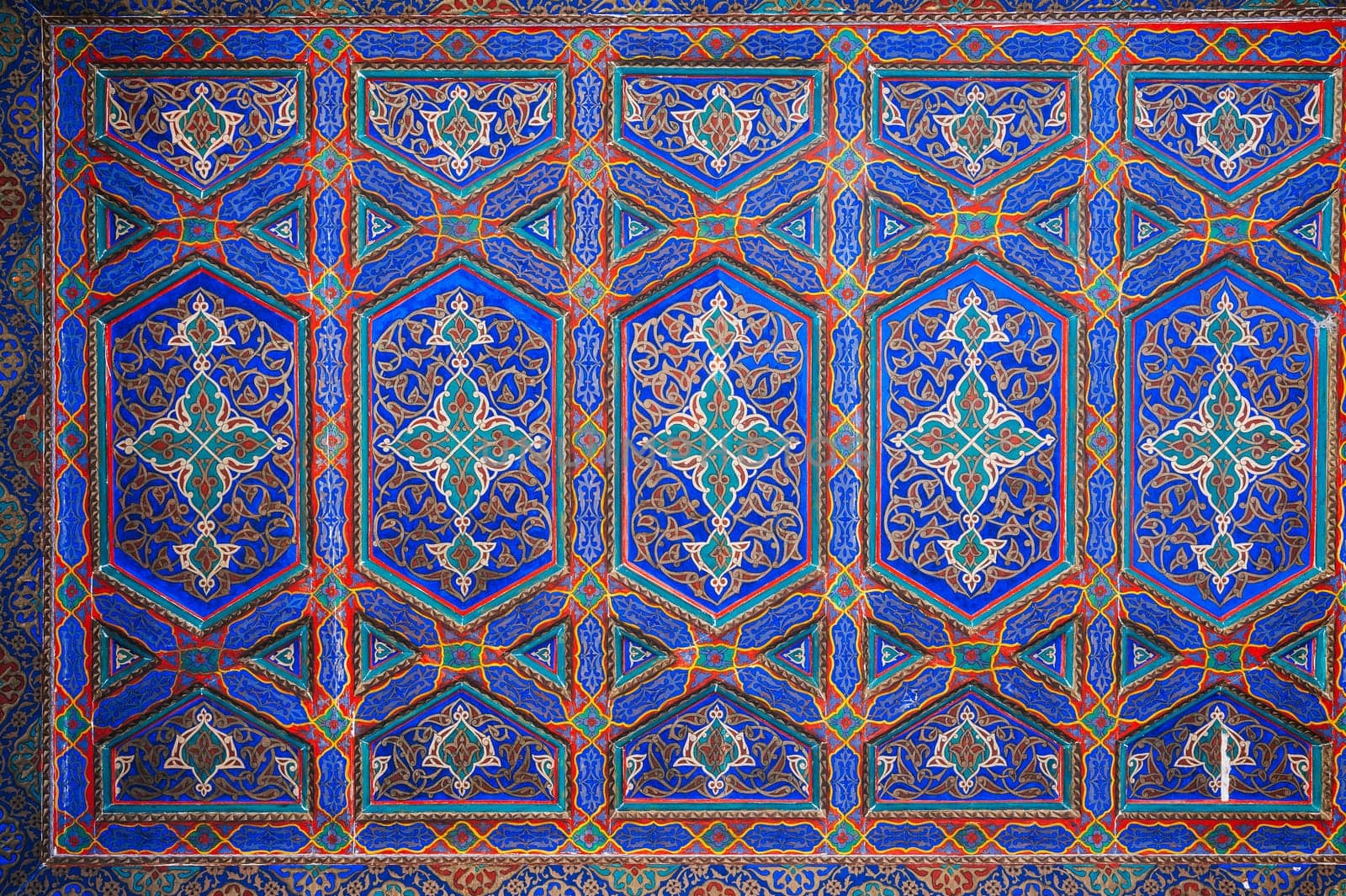 beautiful wooden painted ceiling in the Museum of Art of Uzbekistan with traditional Uzbek ornaments and colorful oriental patterns in Tashkent