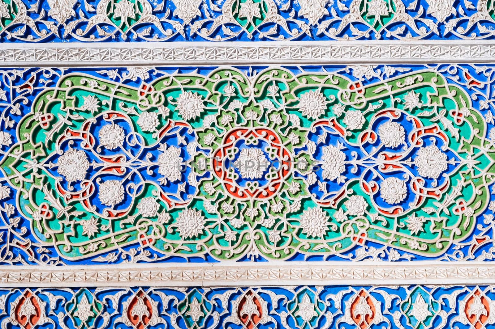 colorful carved wooden painted background with traditional Uzbek ornaments and oriental asian patterns in Tashkent in Uzbekistan