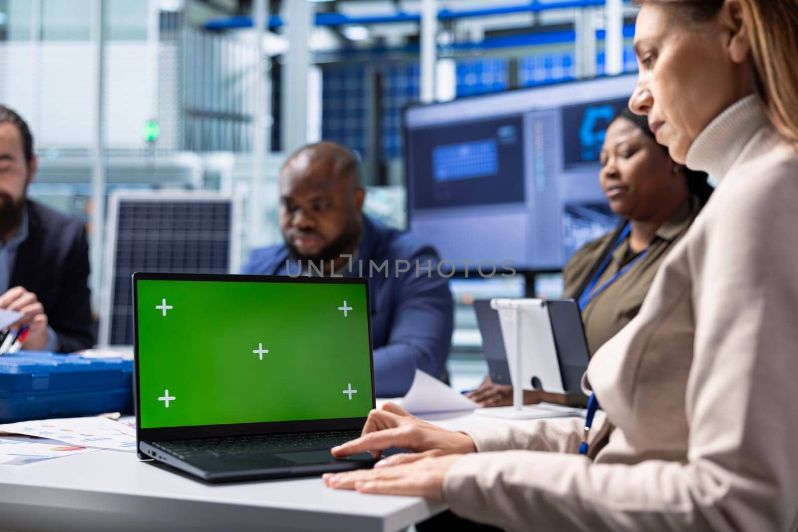 Industrial plant company management executive presents operational insights found during research and development and business strategies to investors using chroma key laptop