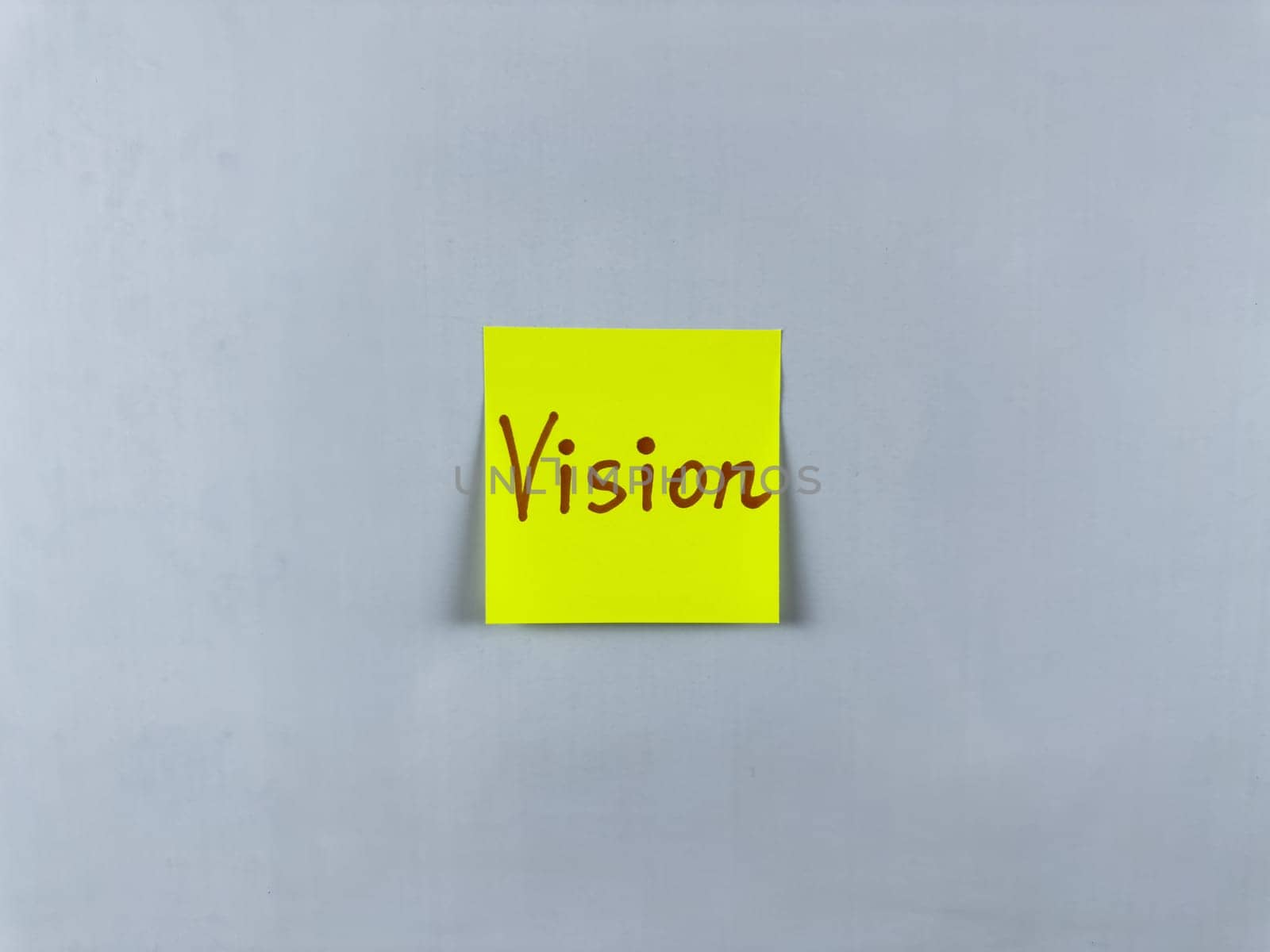 Sticky note with the word Vision written on it, pinned on white background. Photo symbolizes foresight, goals, and inspiration. Perfect for illustrating concepts of vision and future aspirations