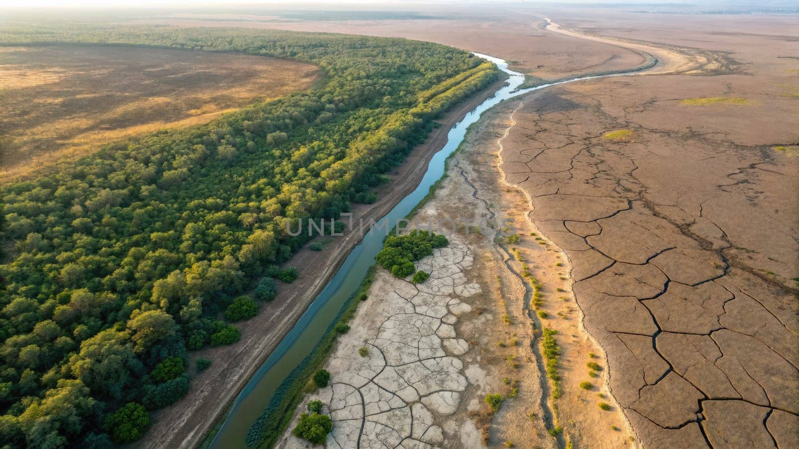 Aerial view shows a river meandering through a parched landscape with significant cracks.