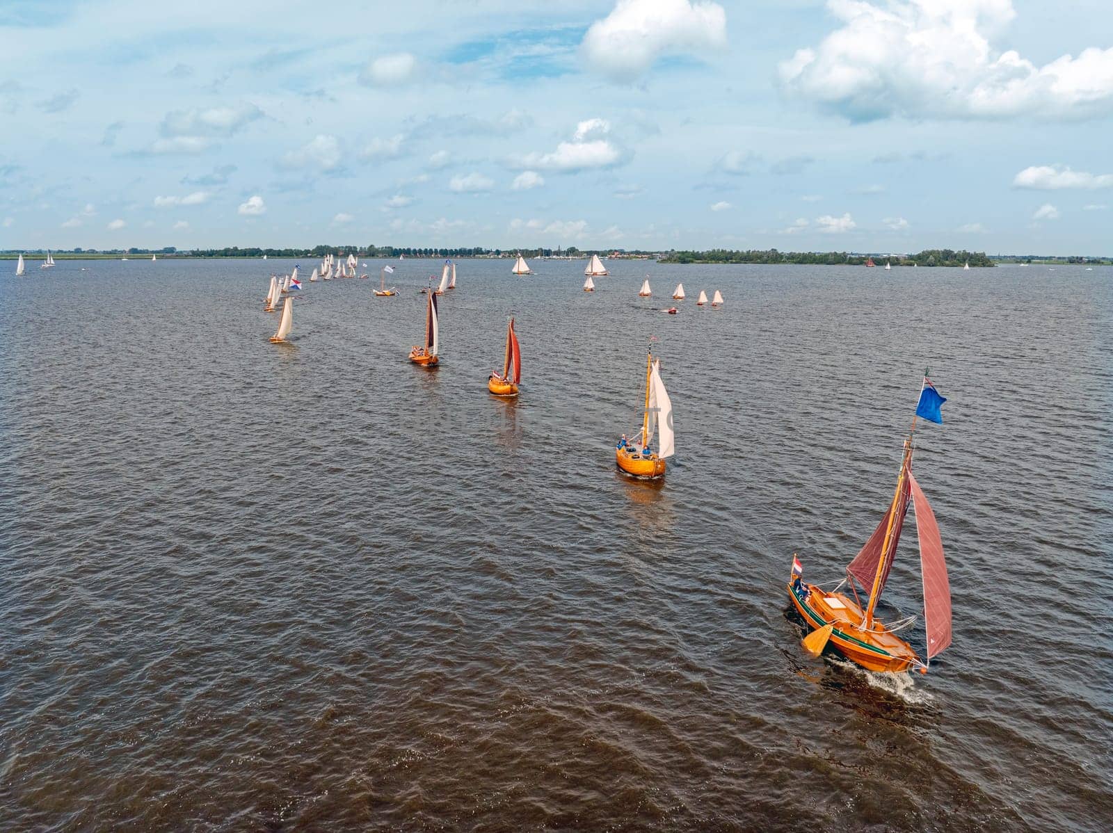 Aerial from admiral sailing with ancient wooden ships on the Heegermeer in Friesland the Netherlands