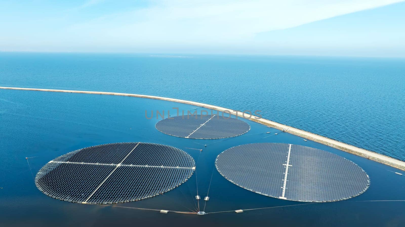 Round solar panels float on the water in the storage basins at Andijk in the Netherlands.