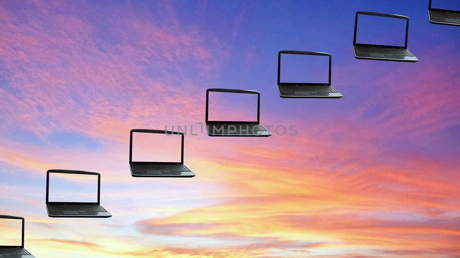 Laptops flying along the sunset  sky, concept cloudcomputing