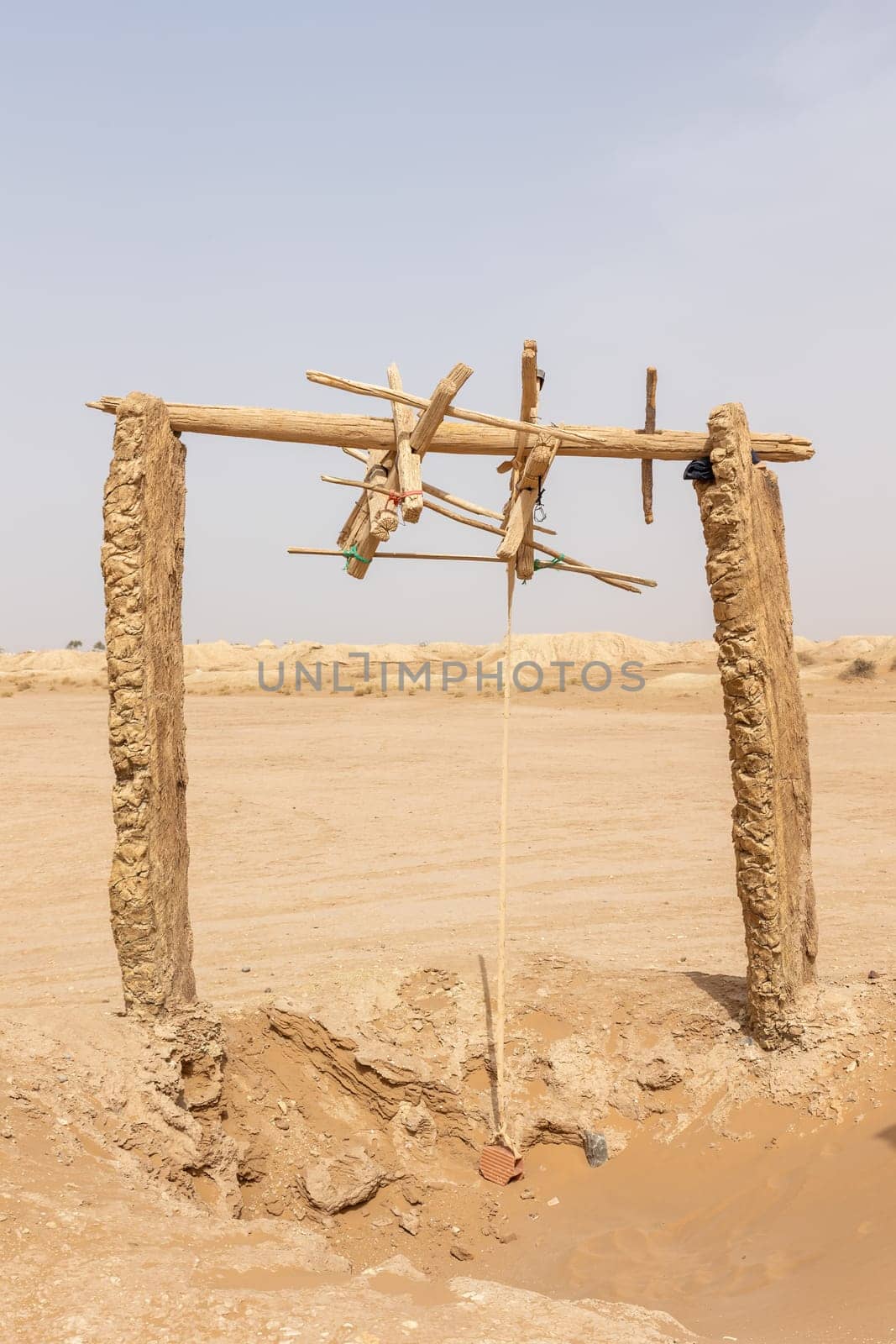 Wooden structure of an old water well.  Western Sahara. Morocco.. Vertically. 
