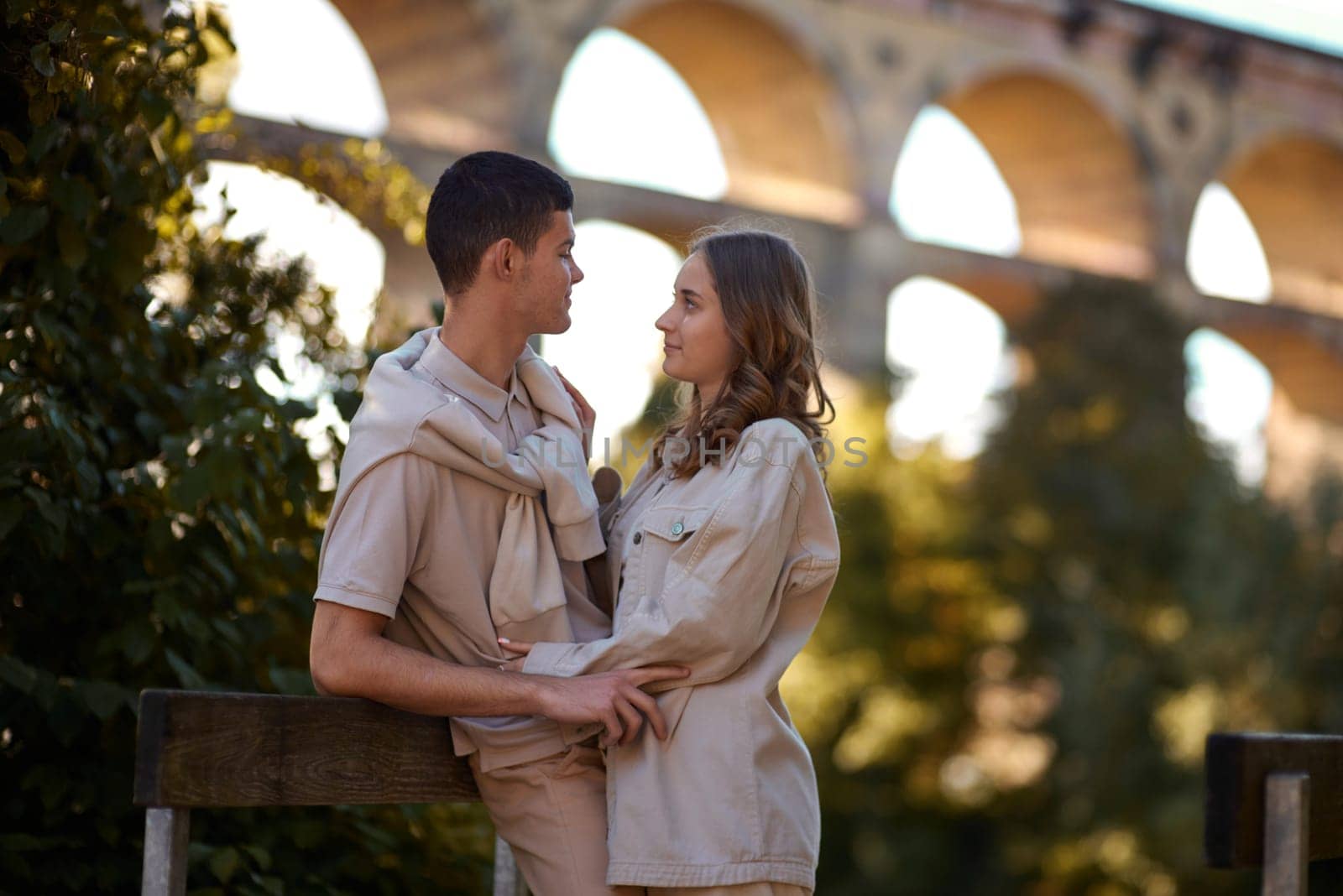 Young Cute Female Hugs Boyfriend. In Autumn Outdoor. Lovers Walking in Park. Attractive Funny Couple. Lovestory in Forest. Man and Woman. Cute Lovers in the Park. Family Concept. Happy Couple.