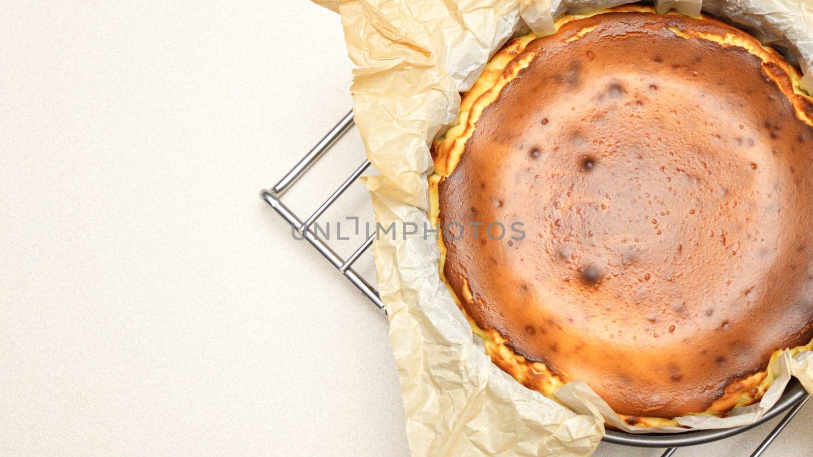 Delicious Cheesecake With caramel Crust And Creamy Filling Baked To Perfection standing on baking rack.