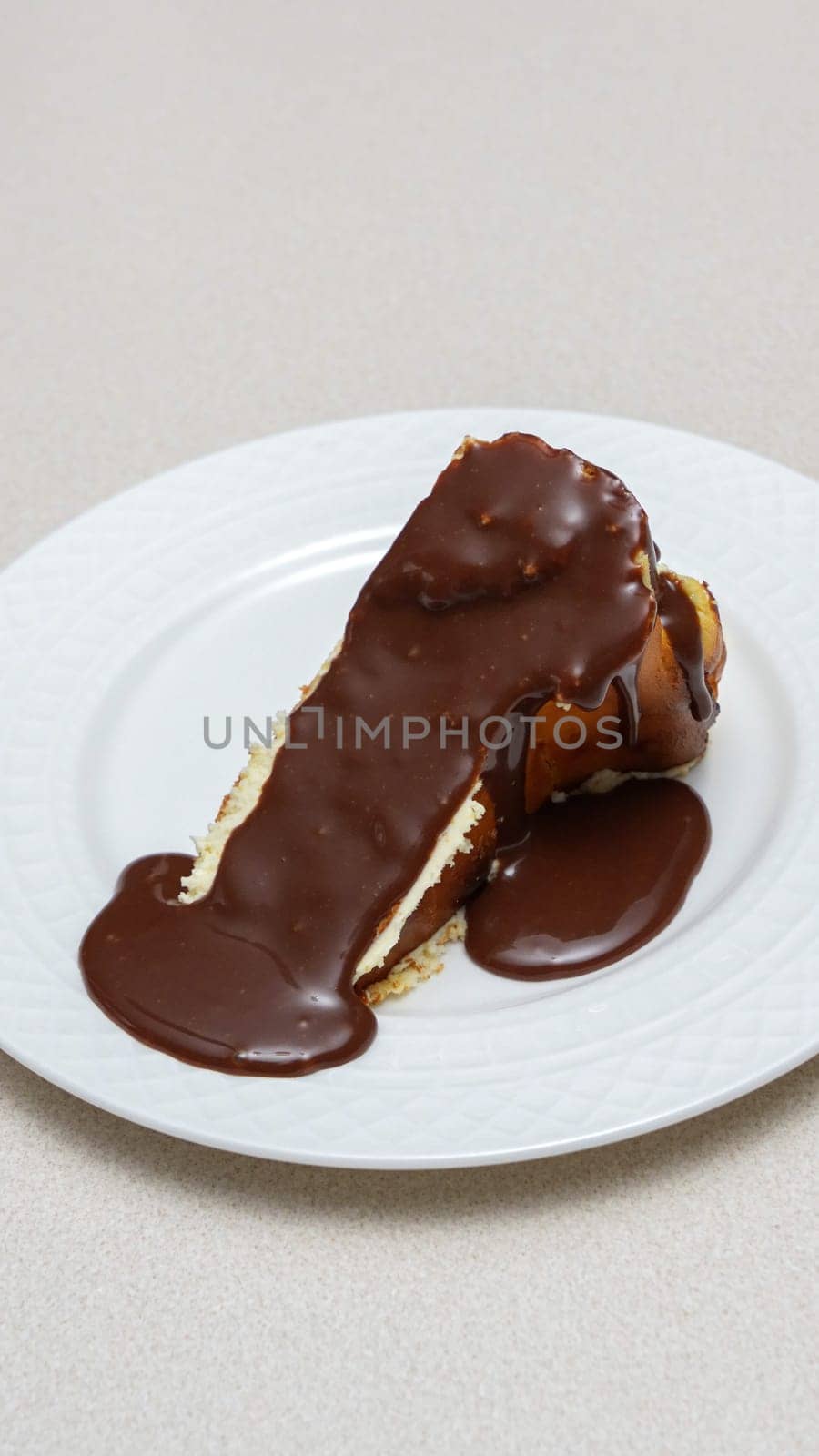 Close-up of a slice of New York-style cheesecake on a white plate
