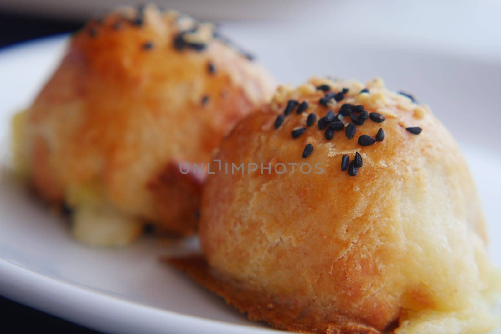 Freshly baked dumplings topped with sesame seeds ready to be enjoyed.