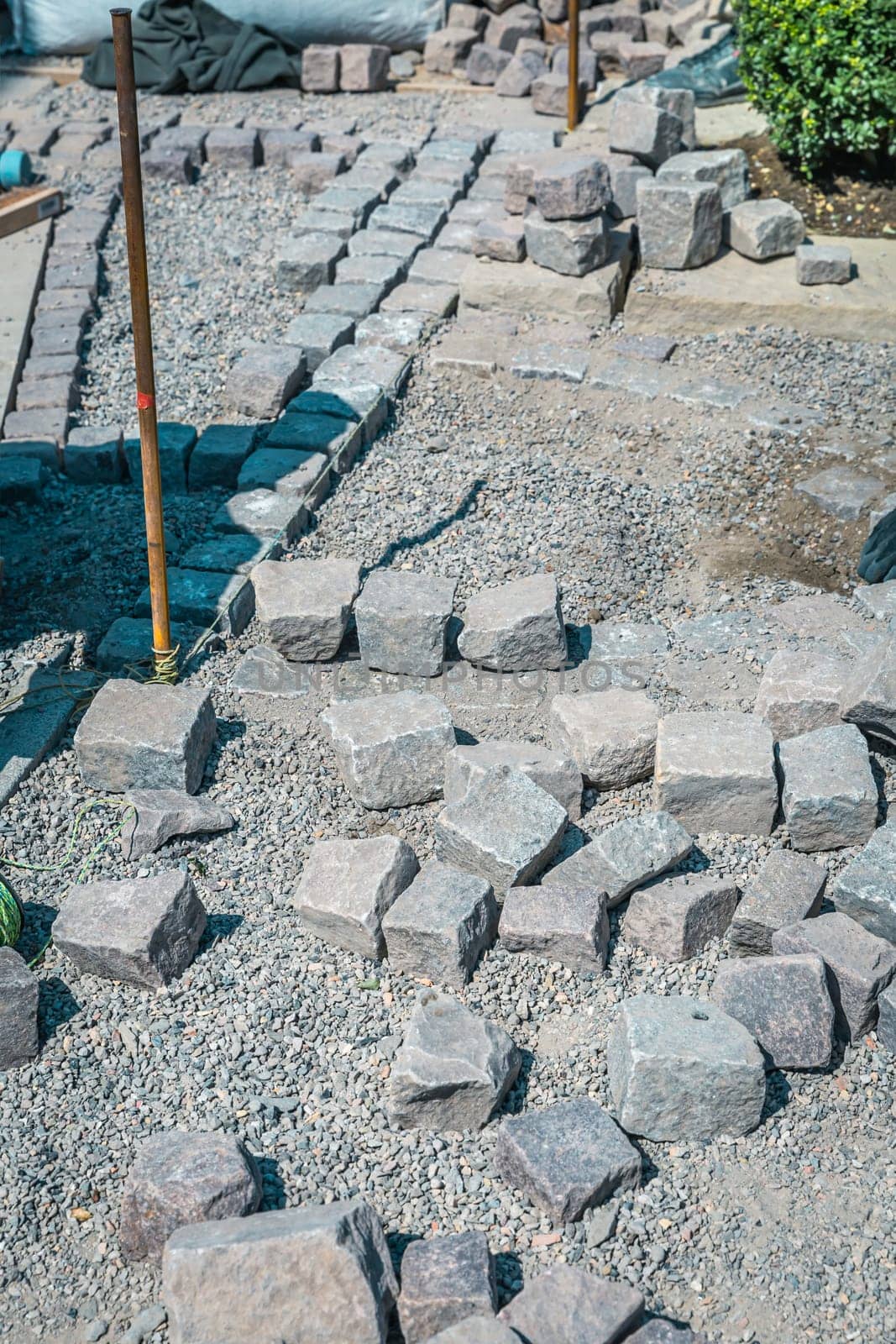 Making path - paving stones, installing and laying pavement stones on terrace, road or sidewalk.