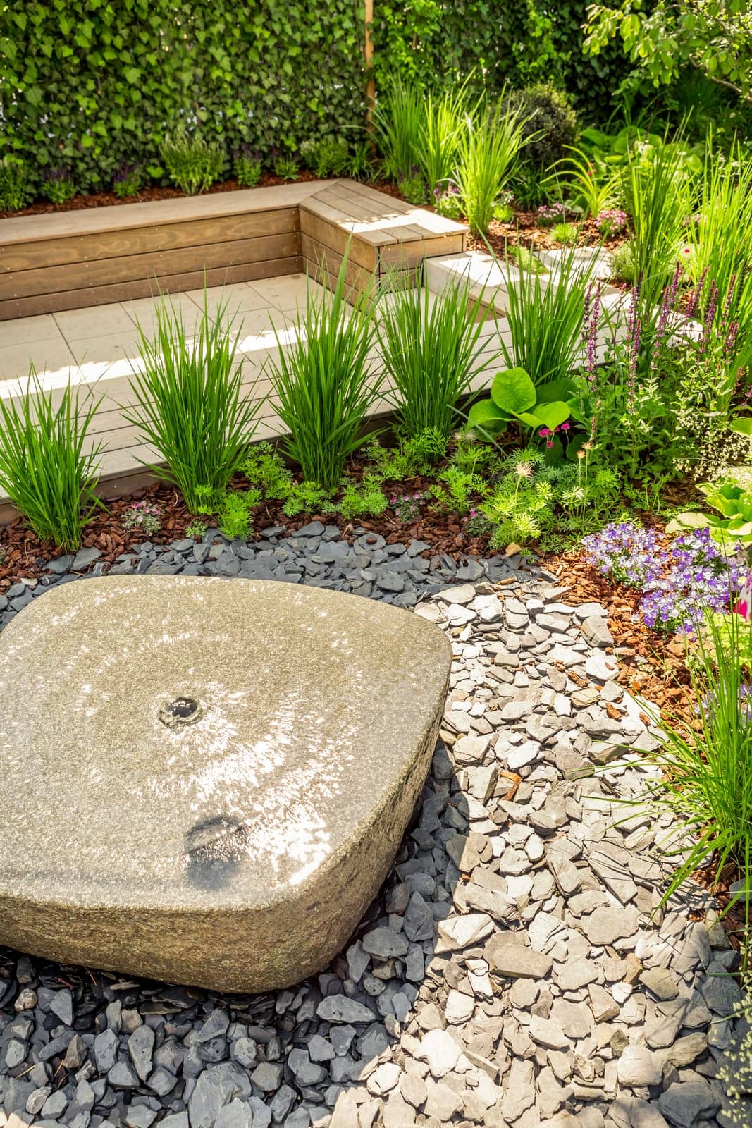 Small water fountain with cozy seating area for terrace, garden or patio