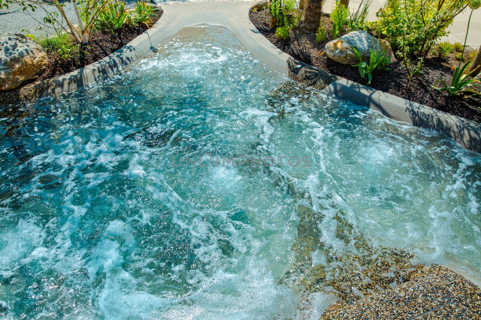 Natural swimming pond or natural spa jacuzzi for a small garden