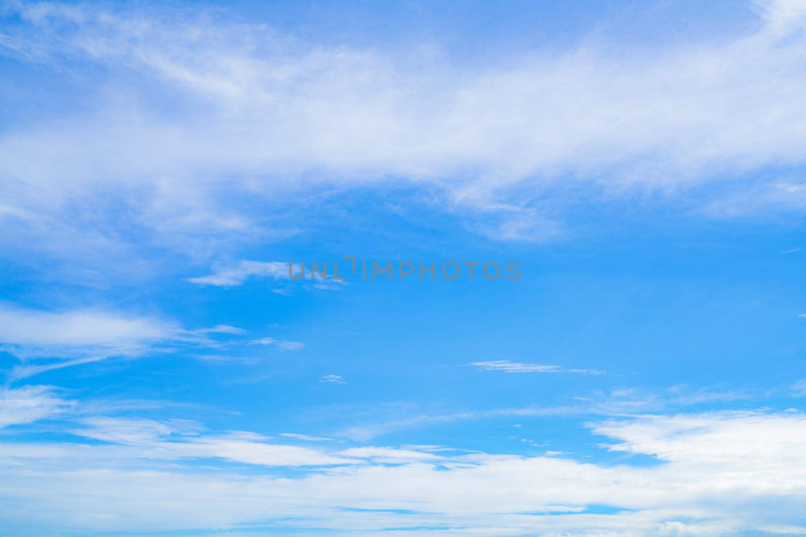 Blue sky and white cirrocumulus clouds texture background. Blue sky on sunny day. Summer sky. Cloud formation. Fluffy clouds. Nice weather in summer season. Weather pattern. Atmospheric phenomenon.