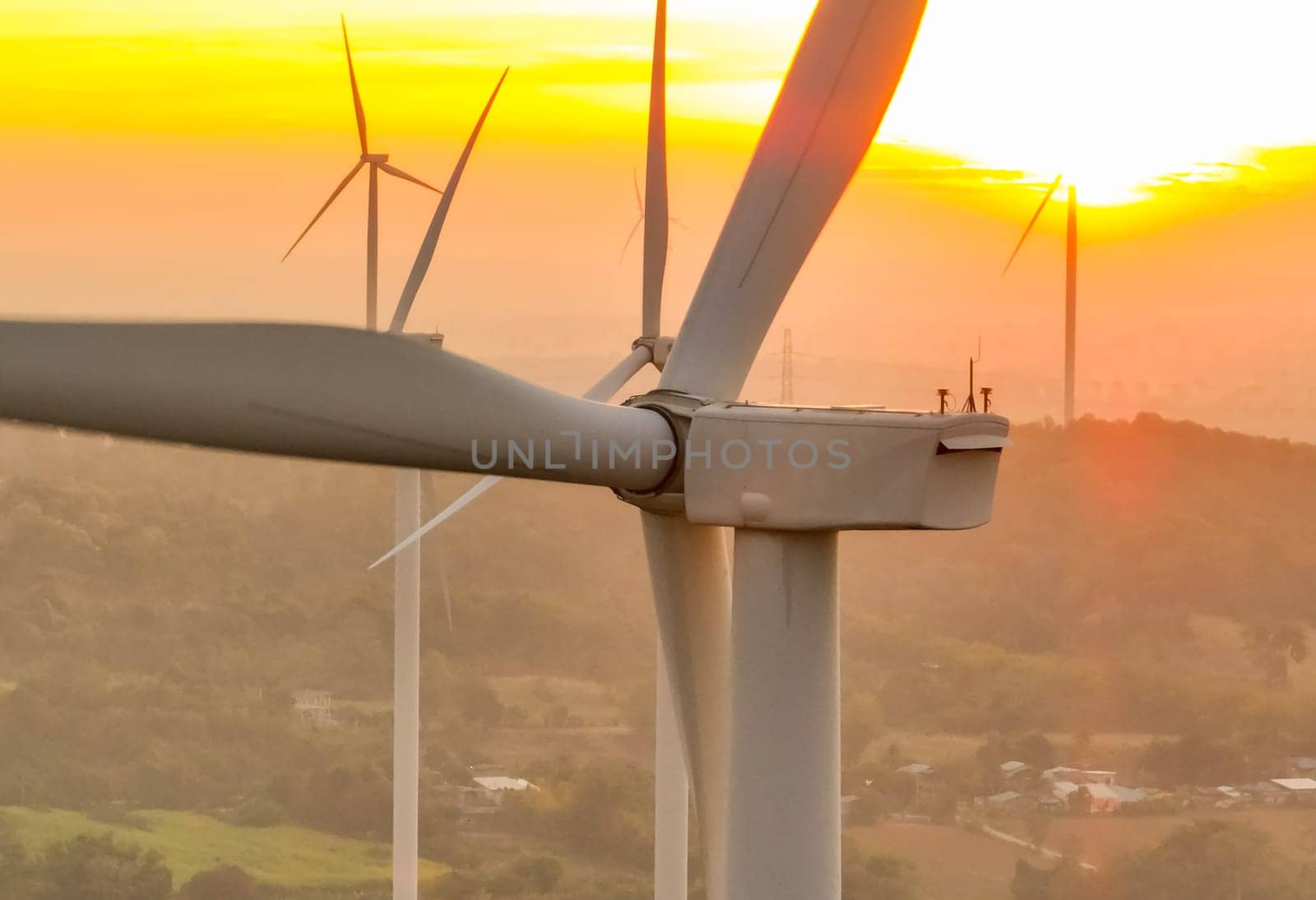 Wind farm field and sunset sky. Wind power. Sustainable, renewable energy. Wind turbines generate electricity. Sustainable development. Green technology for energy sustainability. Eco-friendly energy.