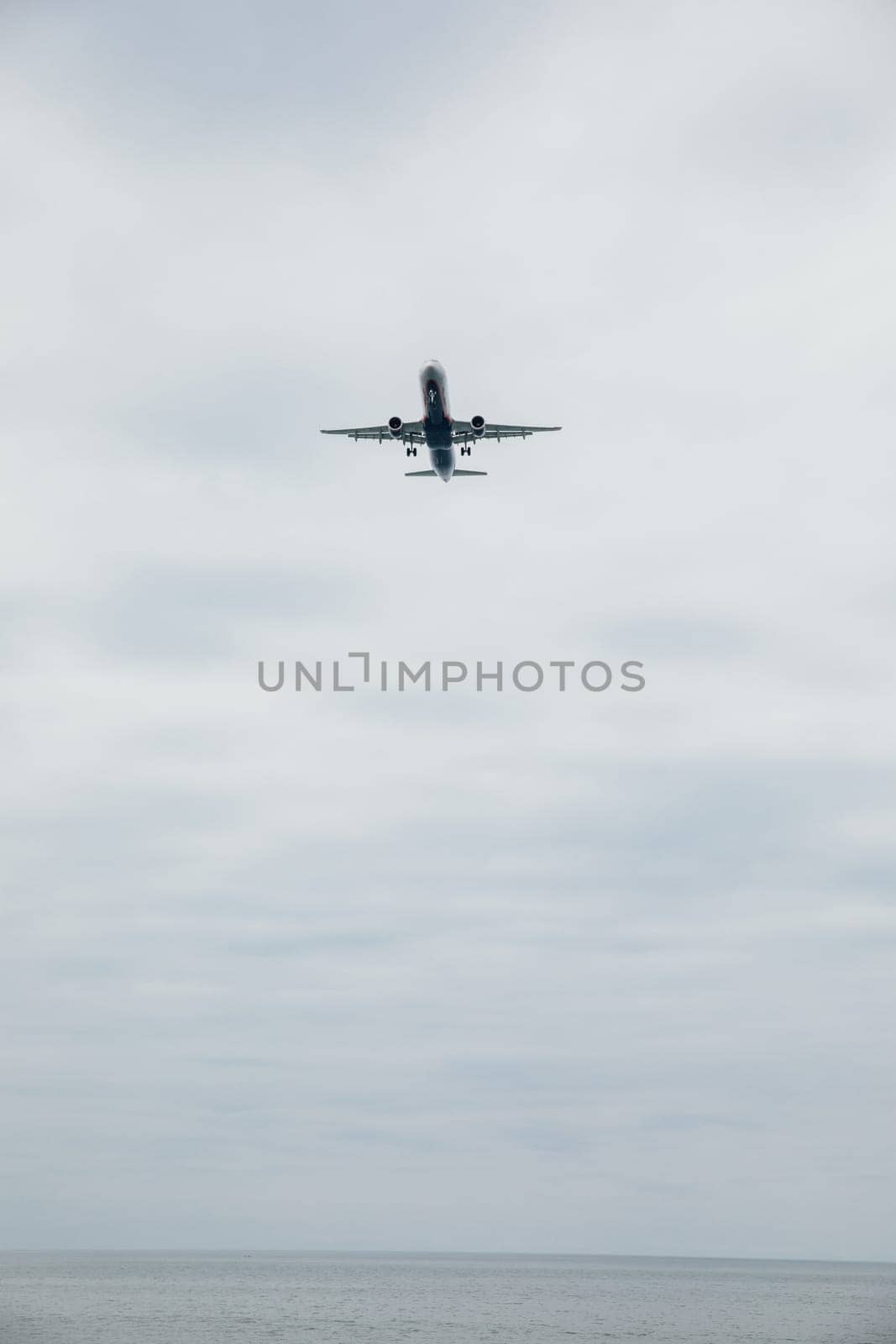 passenger plane flying in the clouds in the sky