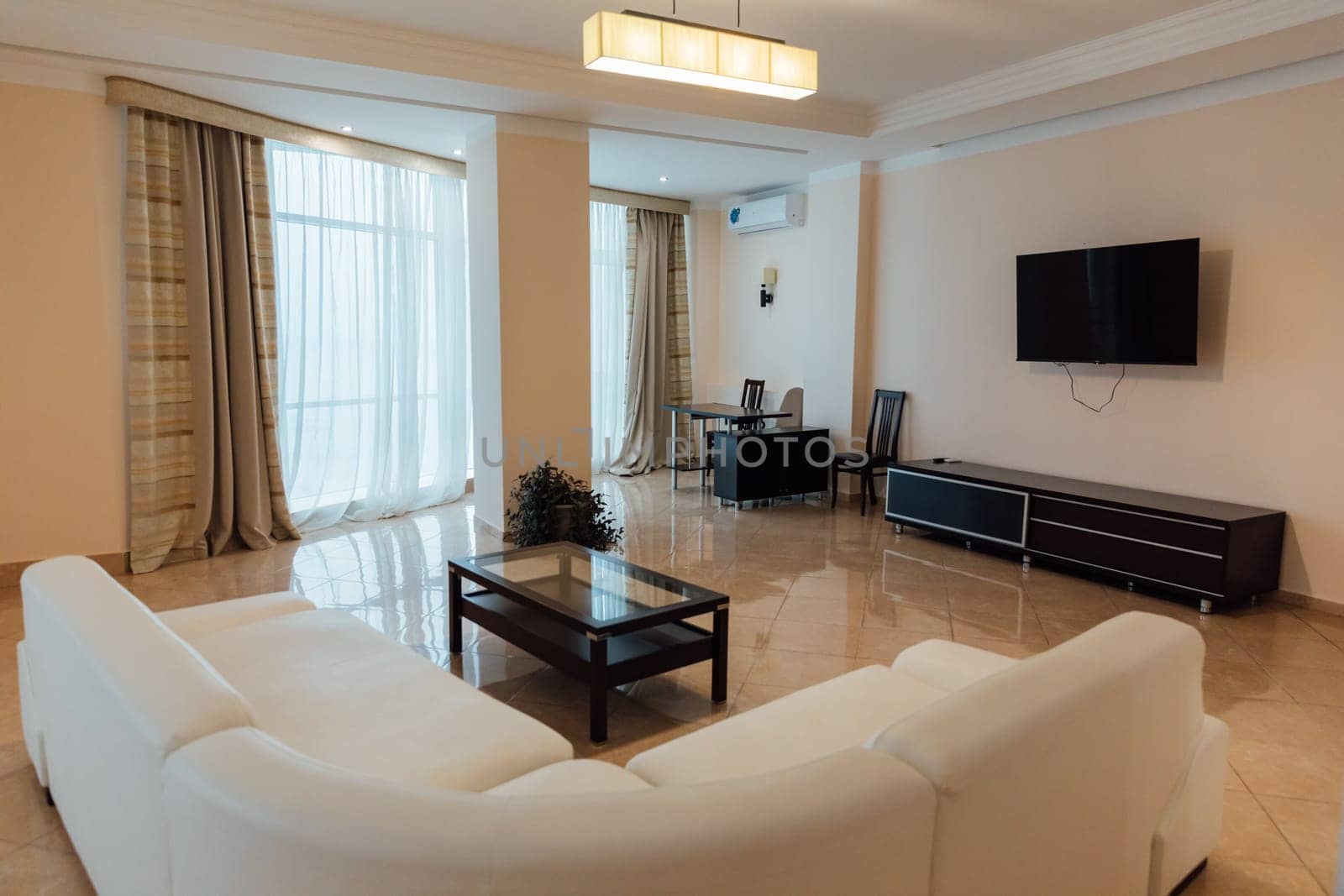Interior of a living room with a sofa and a table with TV