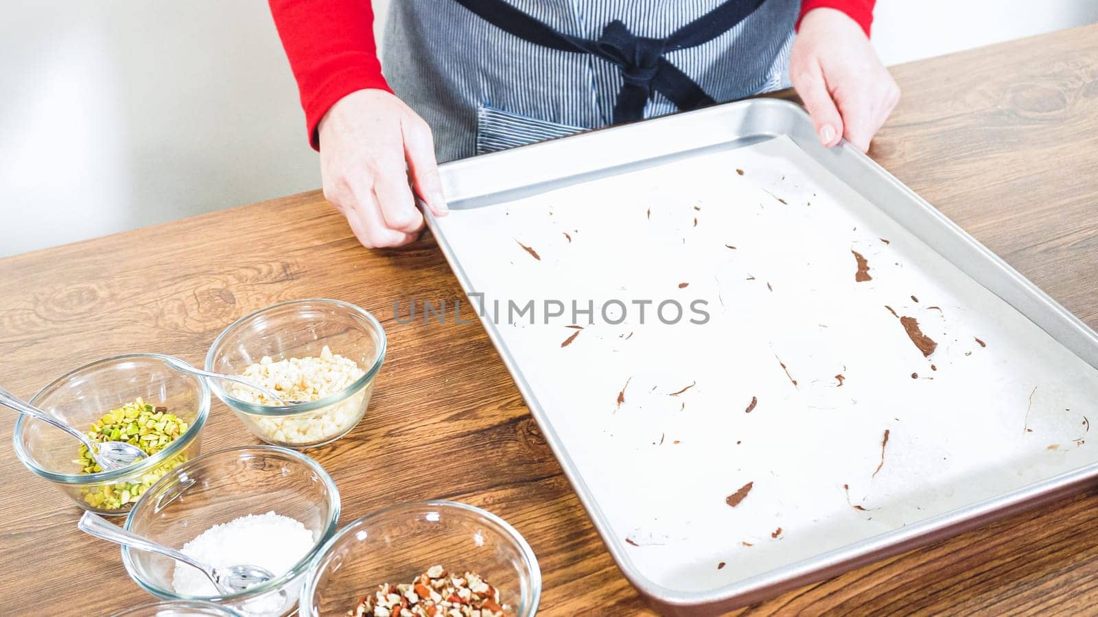 Carefully packaging Christmas cutout cookies, half-dipped in chocolate and presented in clear cellophane wrapping, perfect for festive gifting.