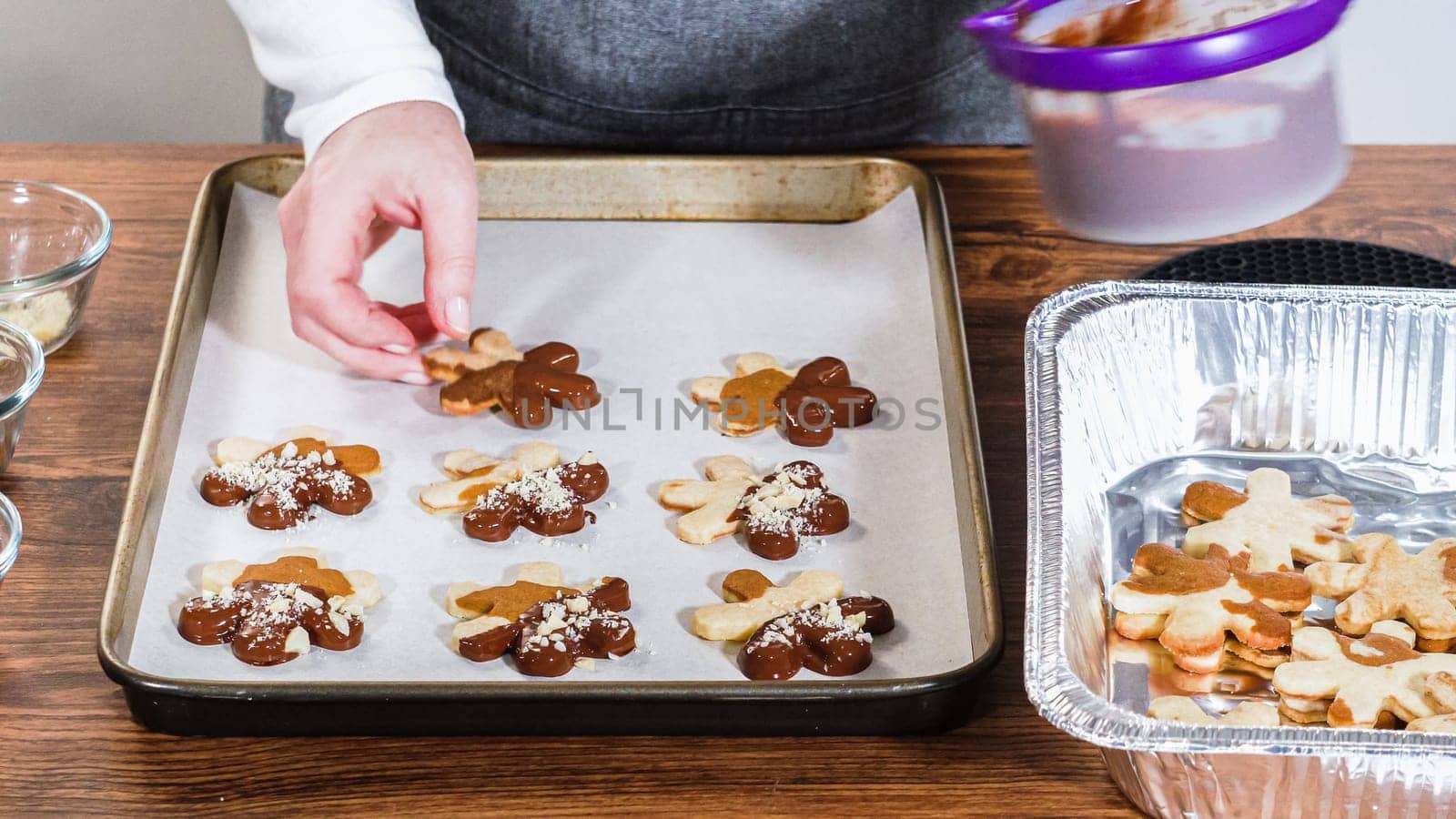Crafting gingerbread cookie sandwiches with eggnog buttercream, presented on a rustic wooden table for Christmas gifting.