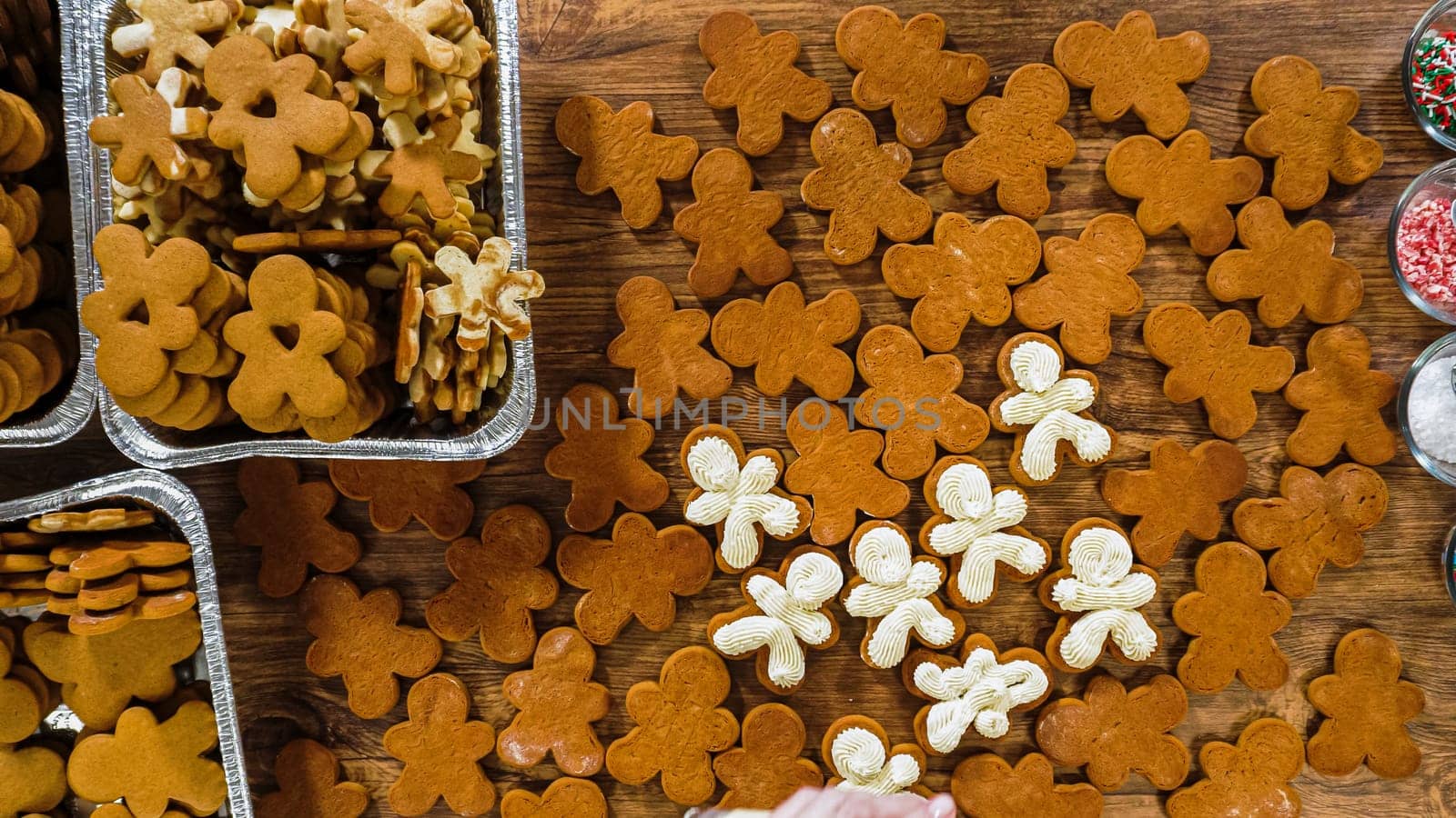 Flat lay. Crafting gingerbread cookie sandwiches with eggnog buttercream, presented on a rustic wooden table for Christmas gifting.