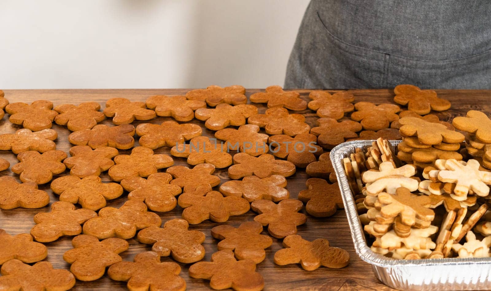 Crafting gingerbread cookie sandwiches with eggnog buttercream, presented on a rustic wooden table for Christmas gifting.