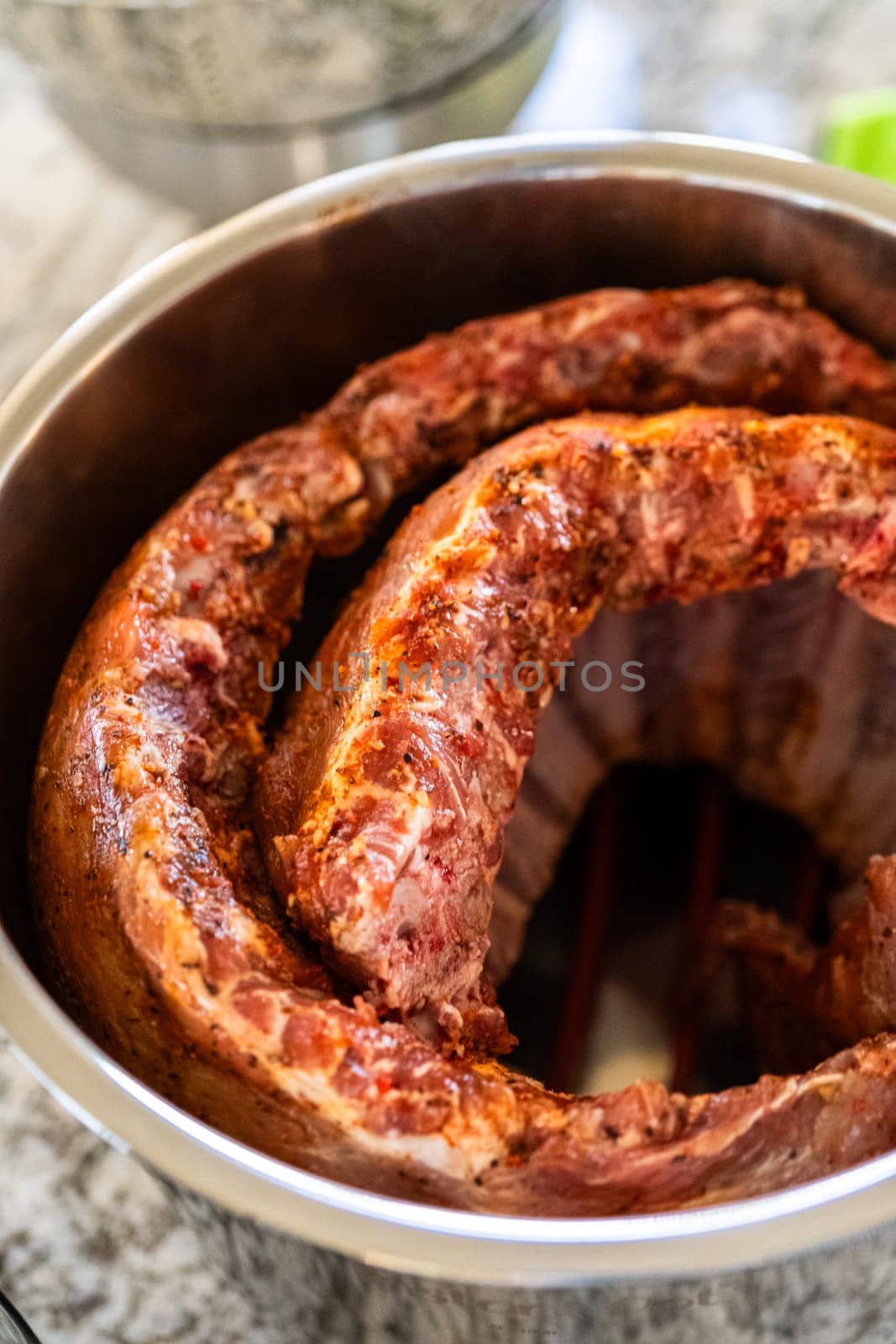 In a sleek modern kitchen, were adding an extra layer of flavor to succulent baby back ribs by infusing them with a medley of spices in a multicooker-a mouthwatering feast in the making.