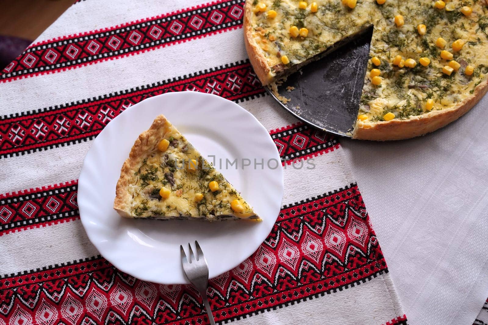Traditional Ukrainian food on the table with embroidered tablecloth.