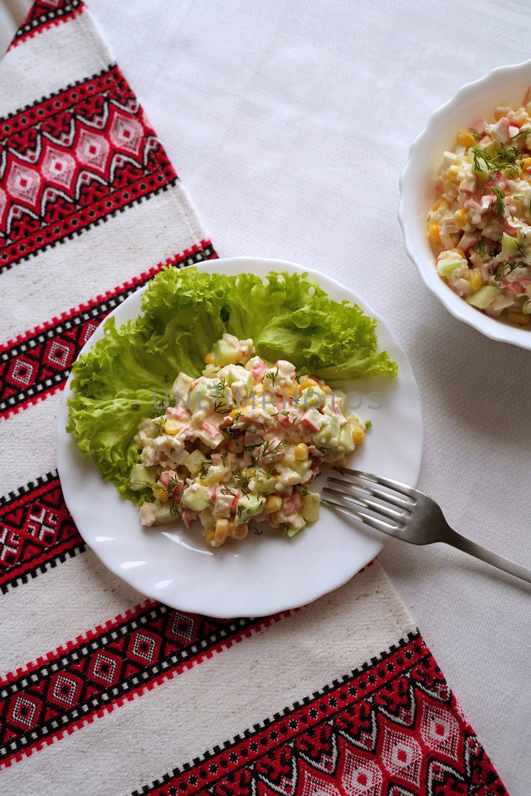 Traditional Ukrainian food on the table with embroidered tablecloth.