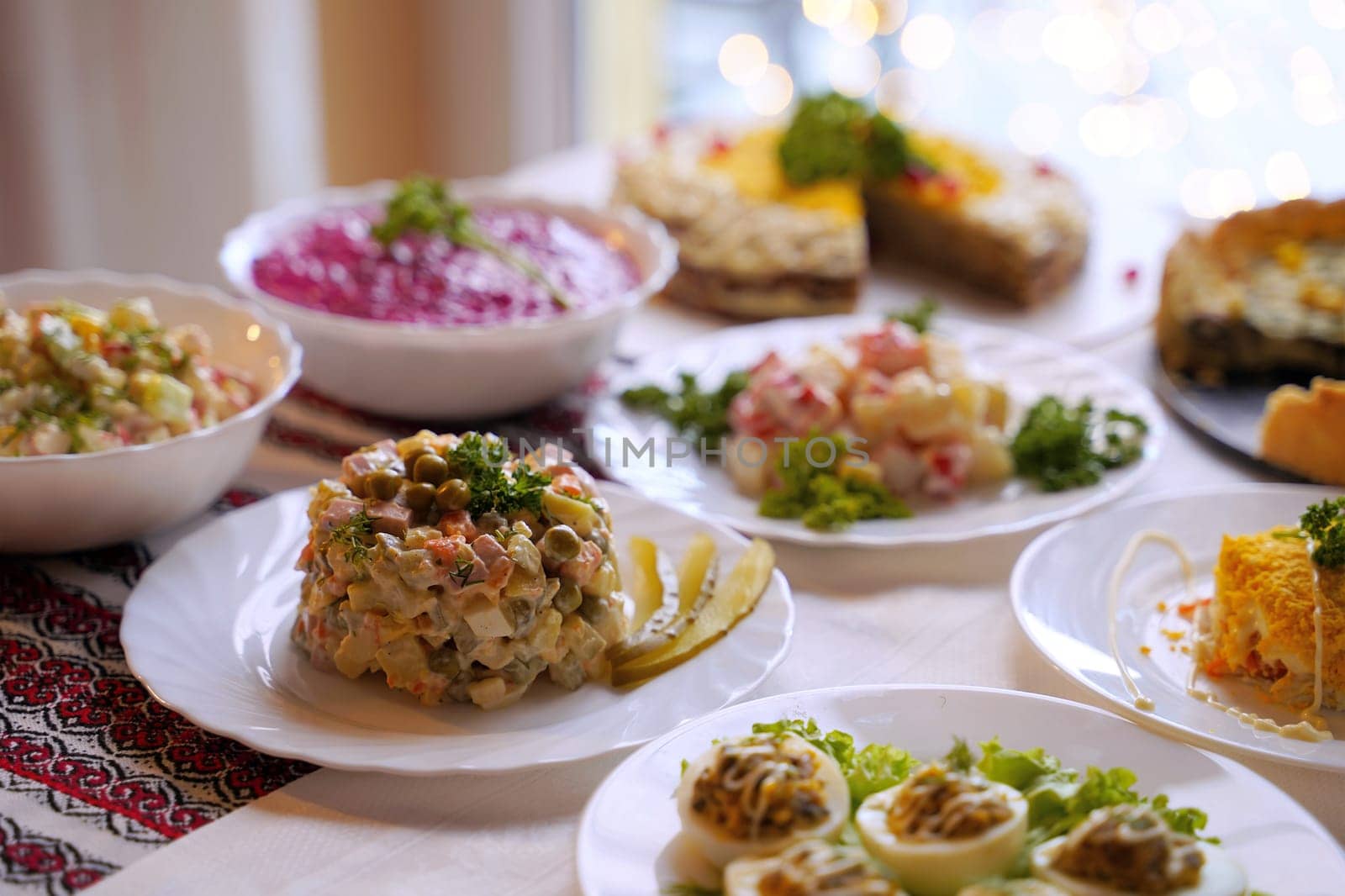 Traditional Ukrainian food on the table with embroidered tablecloth.