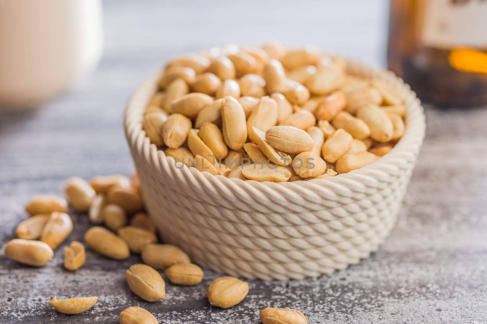 Roasted salted peanuts in bowl on a kitchen table