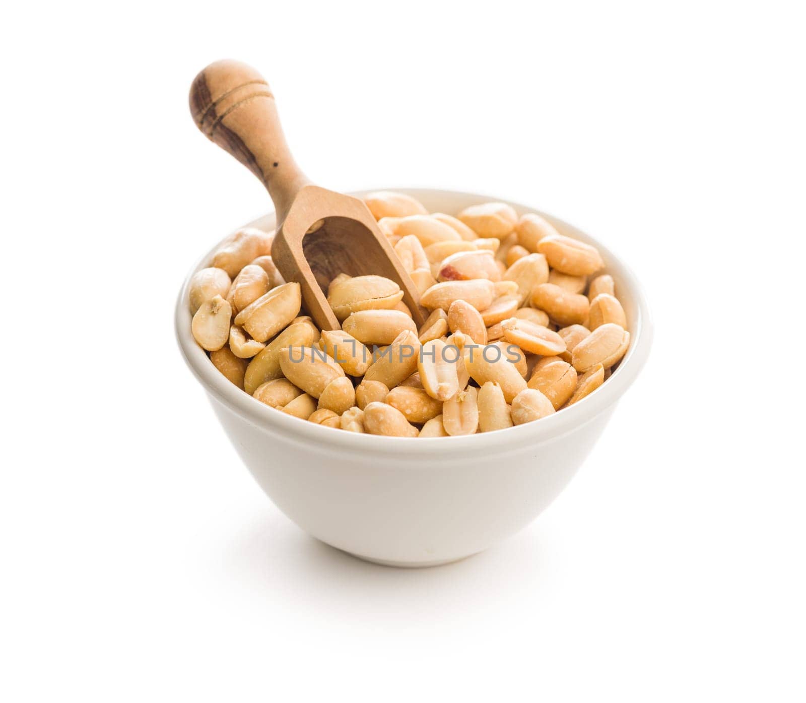 Roasted salted peanuts in bowl isolated on a white background.