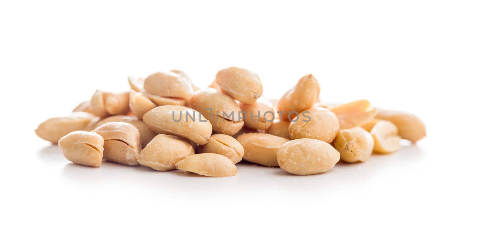 Roasted salted peanuts isolated on a white background.