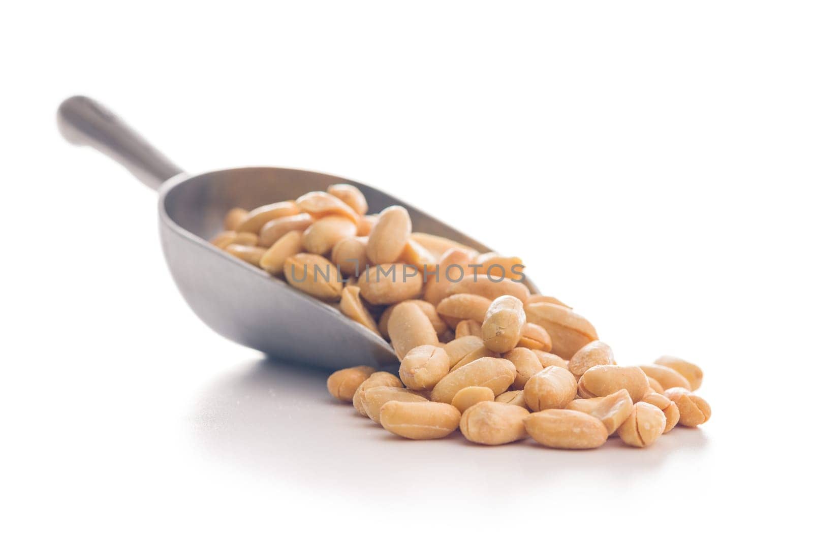 Roasted salted peanuts in scoop isolated on a white background.