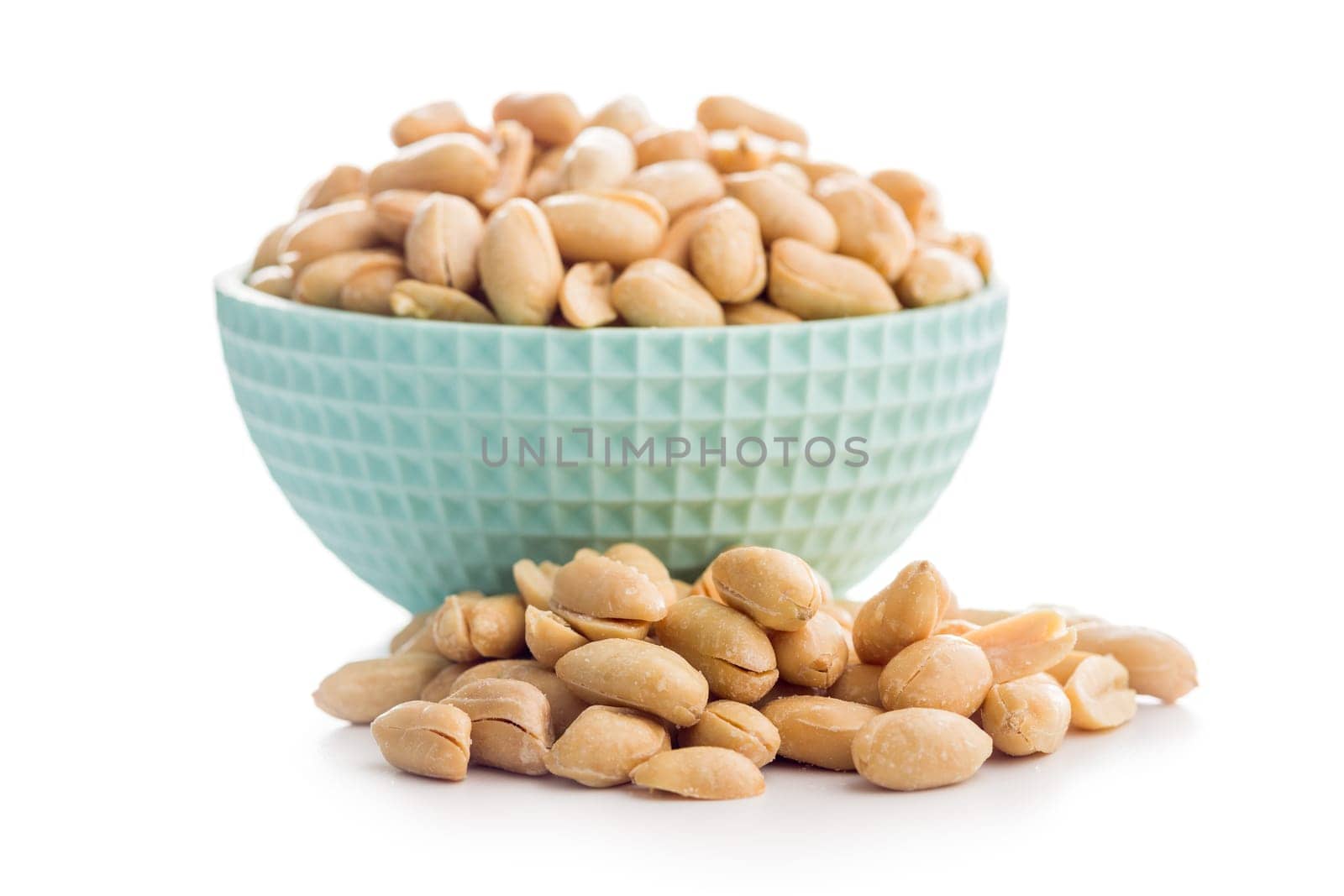 Roasted salted peanuts in bowl isolated on a white background.